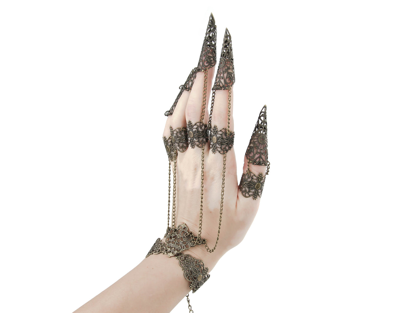 Elegant hand displaying ornate bronze nail rings connected by delicate chains, epitomizing a luxurious gothic beauty and witchy aesthetic, ideal for enhancing a goth-inspired look.