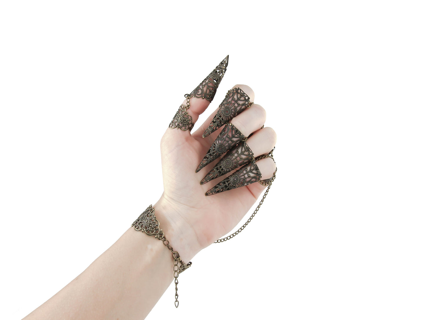 Rear view with the focus on claw rings of an Elegant hand displaying ornate bronze nail rings connected by delicate chains, epitomizing a luxurious gothic beauty and witchy aesthetic, ideal for enhancing a goth-inspired look.
