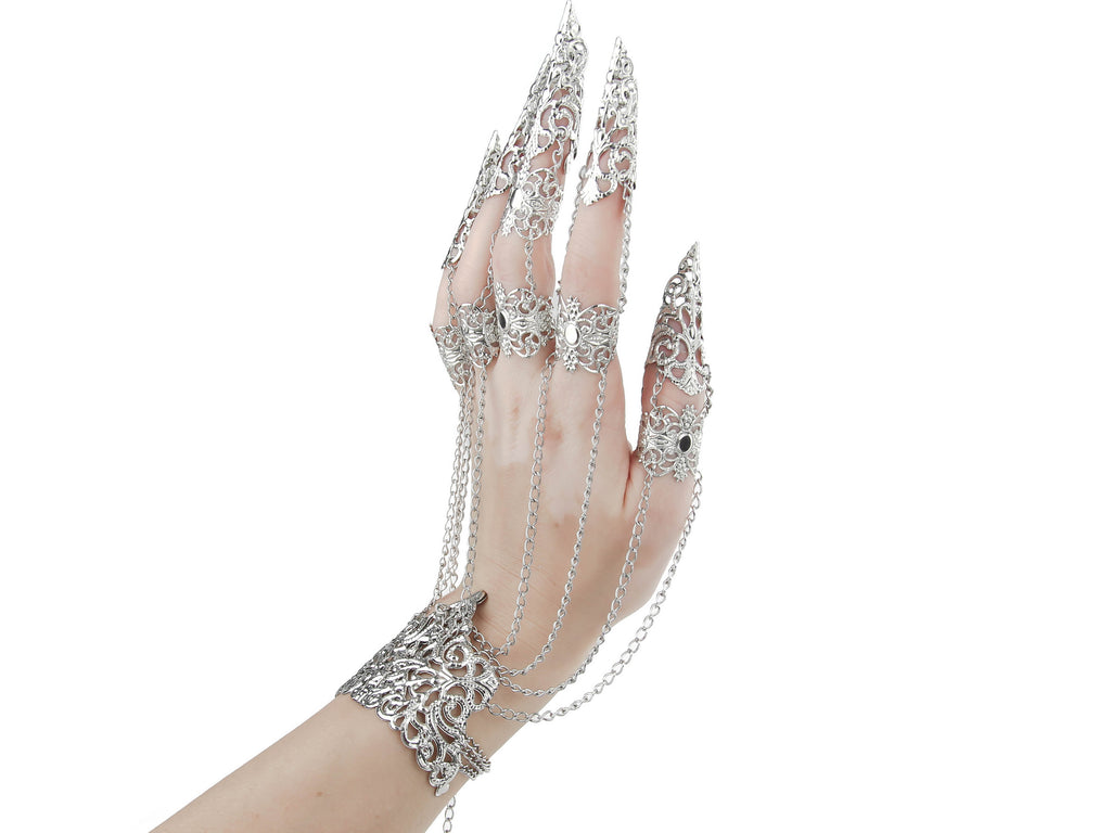 A hand dons a Myril Jewels metal glove with elaborate silver finger claw rings, perfect for a dark avant-garde aesthetic. This statement piece is ideal for those who love gothic-chic jewelry, making it a unique accessory for Halloween, witchcore fashion, or as a bold addition to festival and rave outfits.