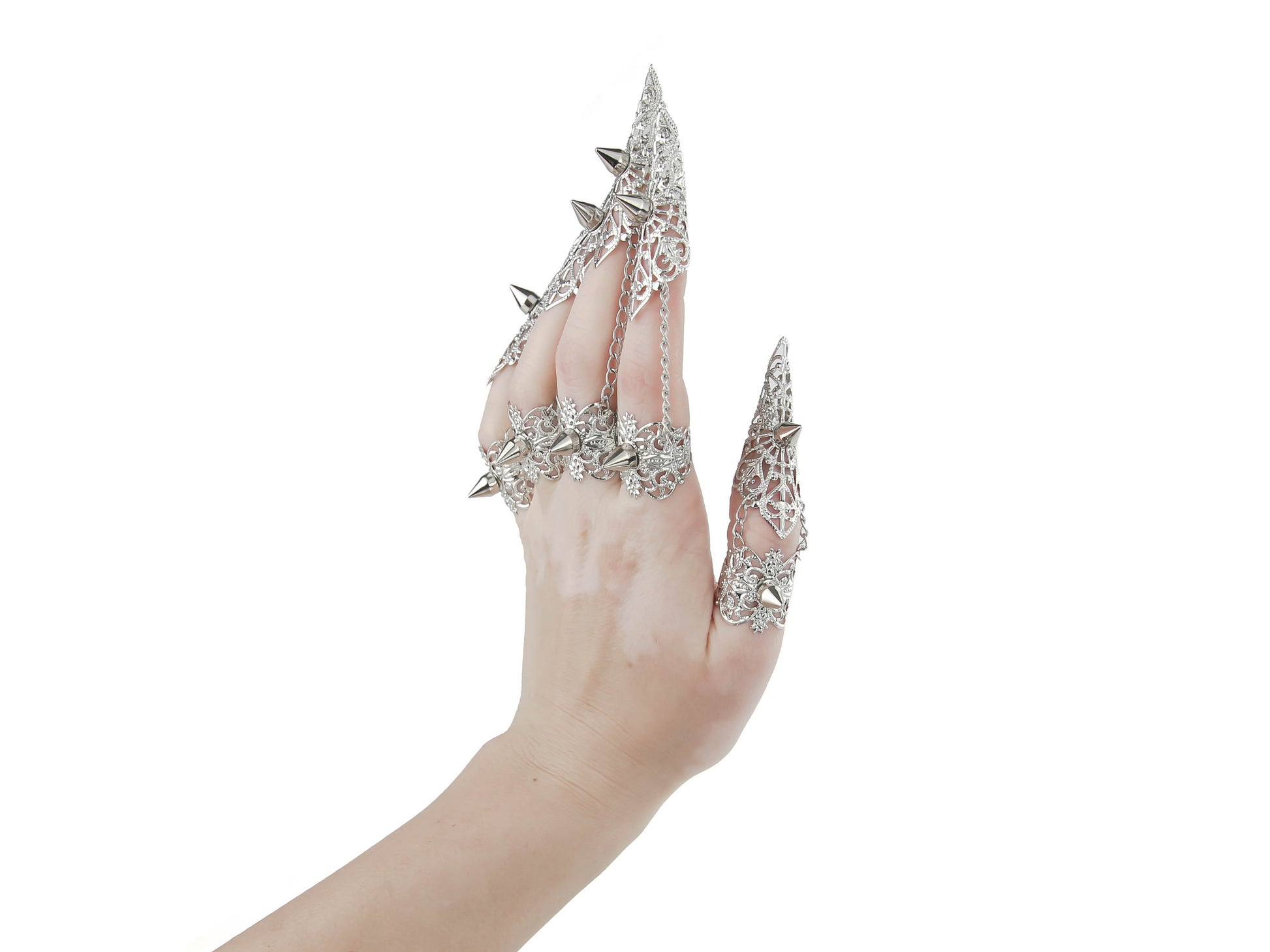 A hand is adorned with a striking set of Myril Jewels silver claw rings, featuring delicate filigree and bold studs. These pieces embody the essence of neo-gothic luxury, perfect for anyone looking to add a touch of dark, avant-garde elegance to their Halloween or everyday gothic-chic style.