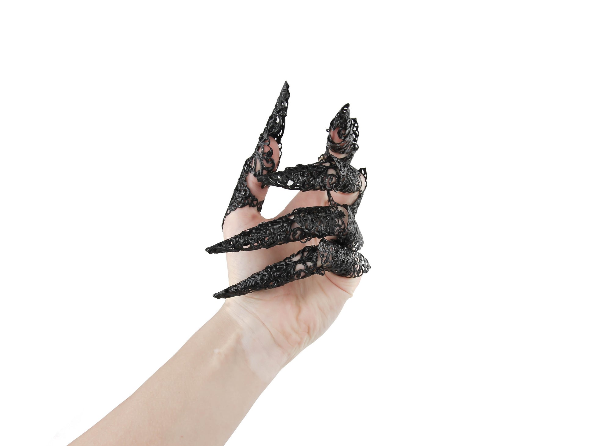 A hand is adorned with a full set of intricate, silver full-finger black claw rings extending into long nail claws, encapsulating a neo-goth aesthetic. These bold, dark-avantgarde pieces from Myril Jewels offer a unique Halloween or everyday wear option for gothic and alternative style enthusiasts seeking festival or rave party jewelry.