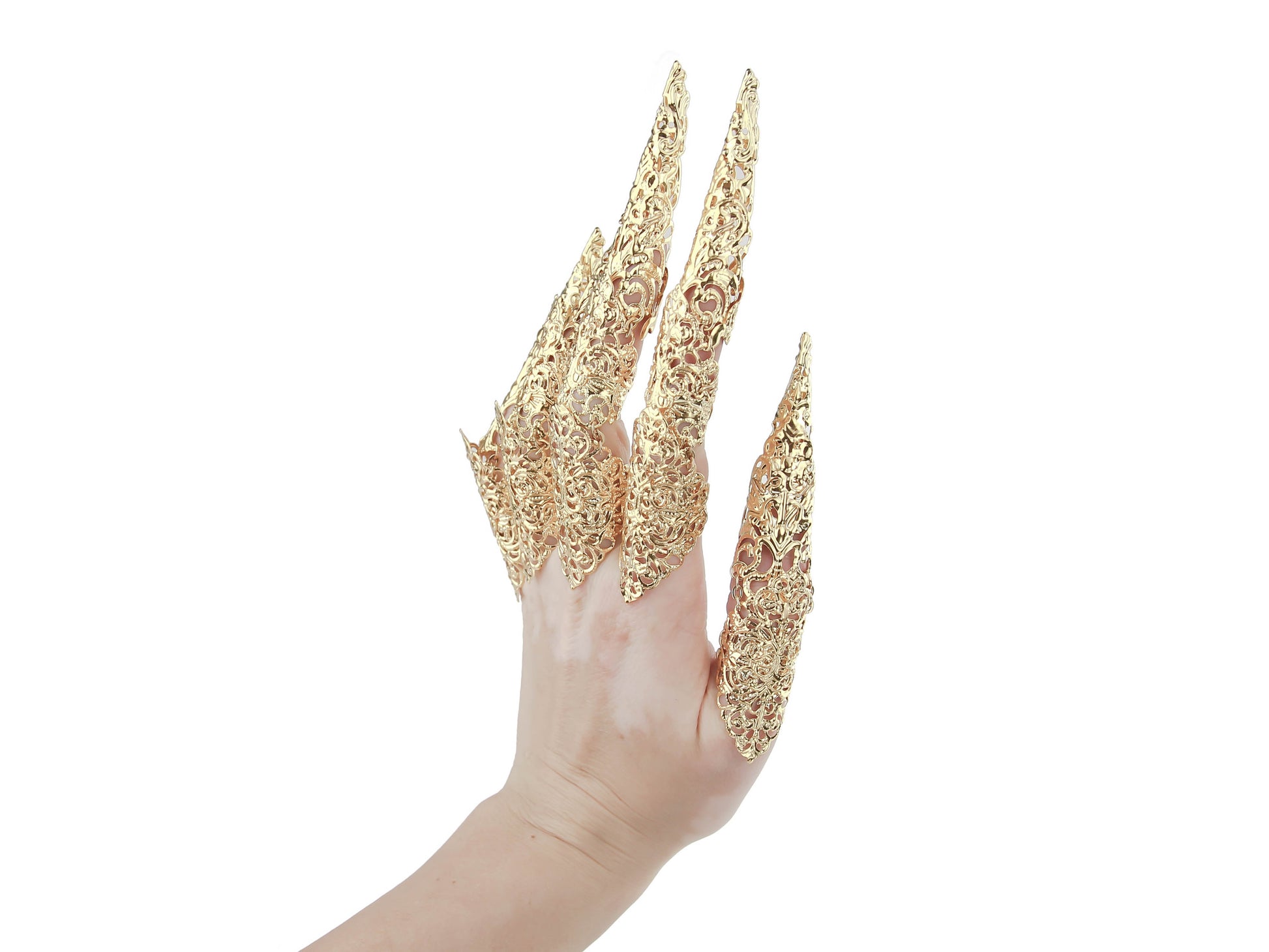 A hand dons an intricate set of full-finger gold claw rings with elongated nails, showcasing a neo goth aesthetic from Myril Jewels. These gold rings merge Halloween Jewelry and Neo Gothic Jewels influences, making a statement piece suitable for gothic-chic enthusiasts. Ideal for bold accessorizing, these rings serve as a striking goth girlfriend gift or a standout addition to festival jewels collections