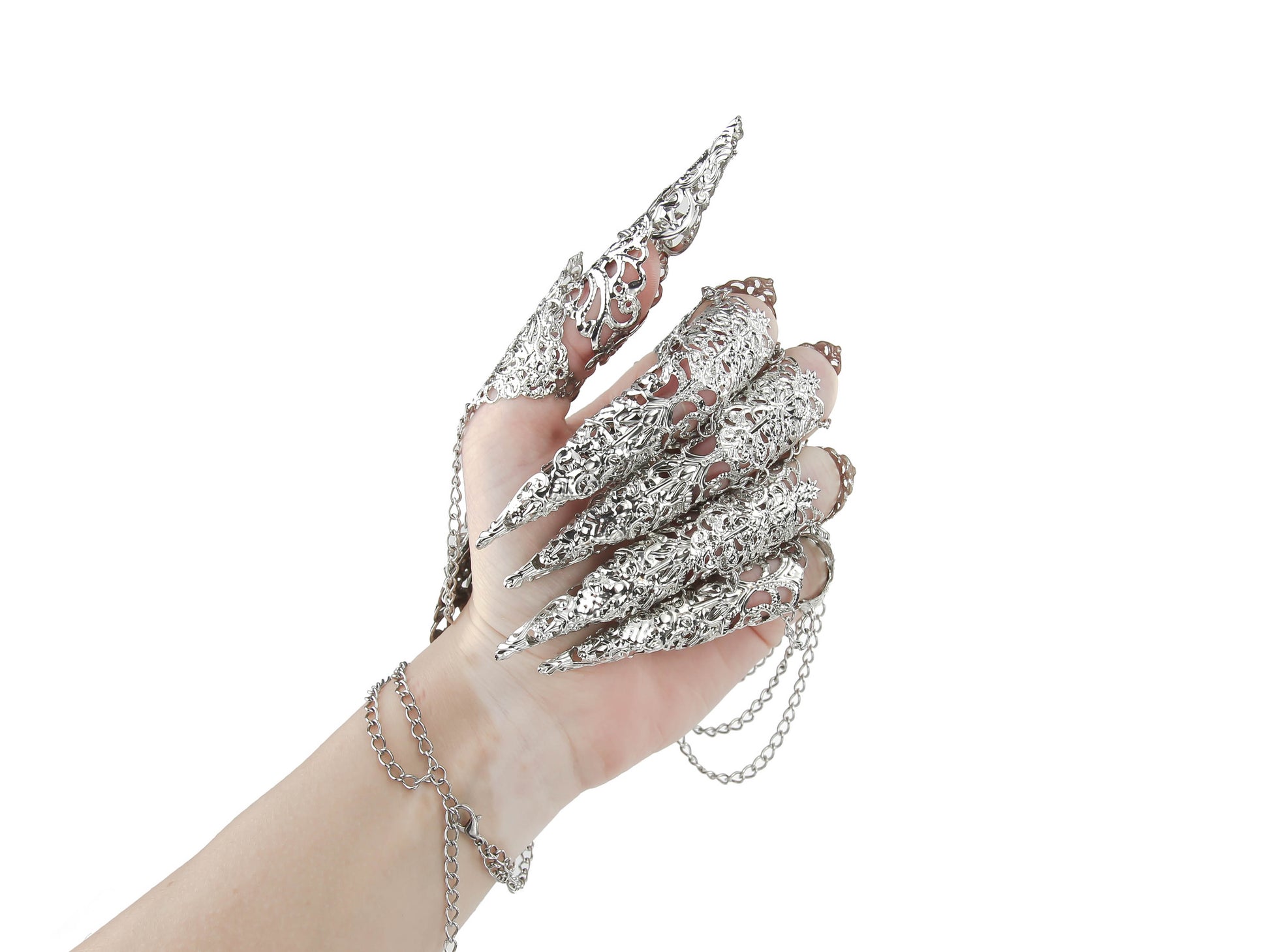 The rear of an almost closed hand over a white background is showcasing Myril Jewels' silver lace finger armor, intertwined with chains, epitomizing dark-avantgarde jewelry. This bold, witchcore accessory is a gothic-chic masterpiece, ideal for Halloween, punk, and neo-gothic fashion statements, crafted with the sophisticated whimsy of Gothic Lolita.