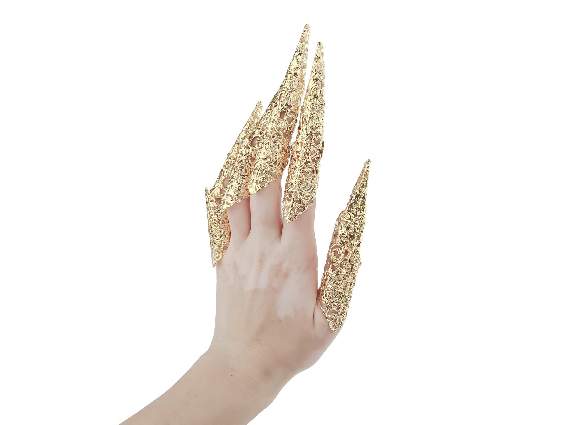 A hand flaunts Myril Jewels' gold midi rings with long claws, embodying dark avant-garde craftsmanship. These unique pieces are perfect for anyone seeking Neo Gothic Jewels, adding a daring touch to both gothic-chic styles and bold festival attire