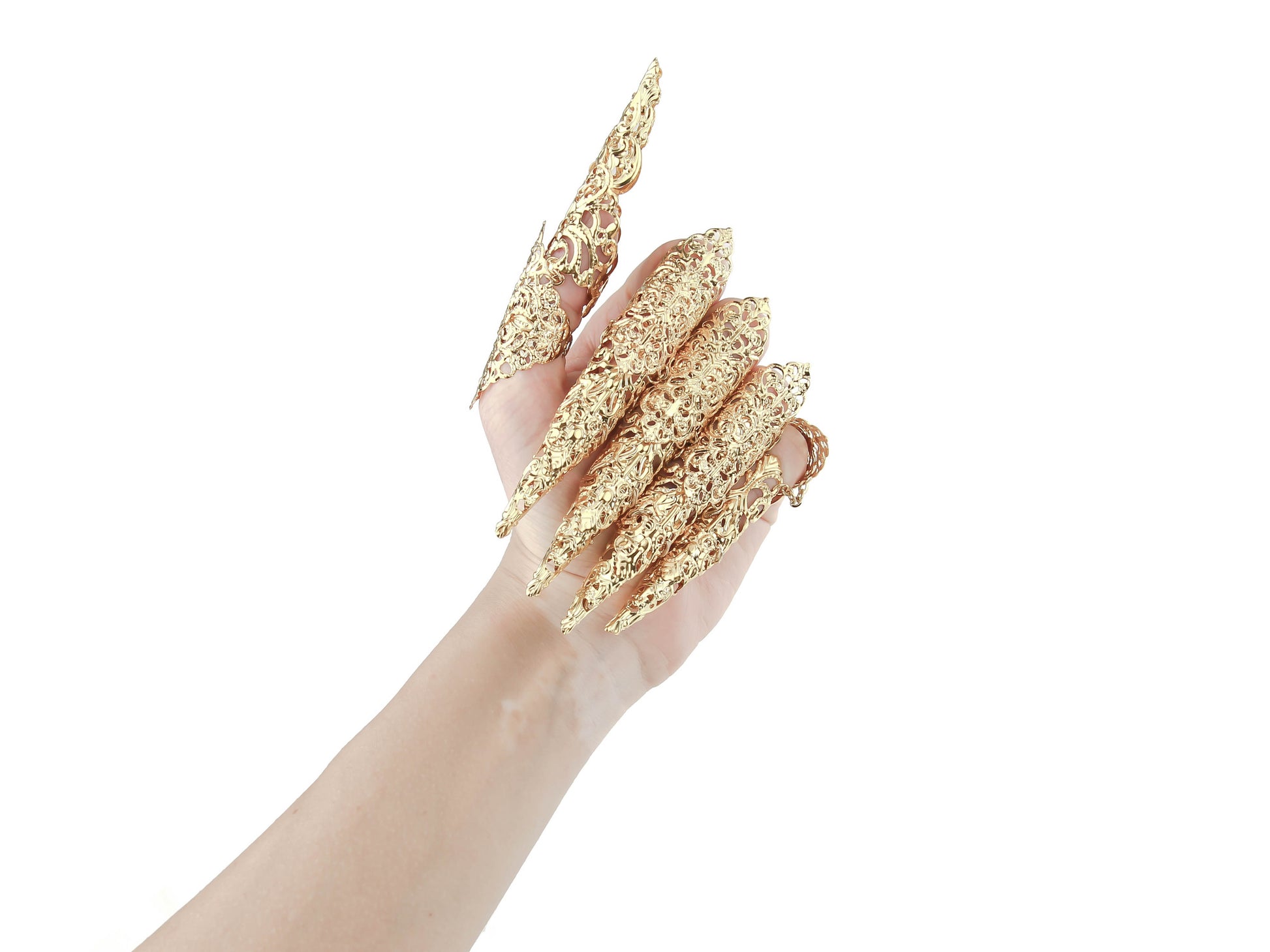 A hand flaunts Myril Jewels' gold midi rings with long claws, embodying dark avant-garde craftsmanship. These unique pieces are perfect for anyone seeking Neo Gothic Jewels, adding a daring touch to both gothic-chic styles and bold festival attire