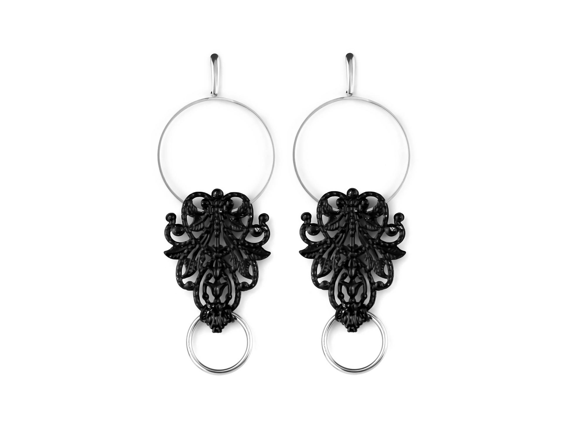 This image features a pair of black and silver filigree hoop earrings from Myril Jewels, perfect for those with a taste for dark, avant-garde accessories. The intricate filigree design on the earrings exudes gothic charm, making them suitable for a Halloween ensemble, everyday goth wear, or as an eye-catching addition to a festival outfit. They serve as a bold statement piece for anyone embracing a neo-gothic, witchcore, or whimsigoth aesthetic.