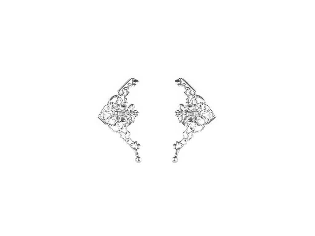 Presenting Myril Jewels' intricate cuff earrings, a masterpiece of neo-gothic design. These silver earrings feature an ornate, web-like pattern with a central floral motif, embodying the gothic-chic aesthetic. They dangle gracefully, perfect for adding a touch of whimsigoth elegance to any ensemble. Ideal for those who favor dark-avantgarde accessories, they're versatile for daily wear or as a highlight for rave party attire, encapsulating the essence of festival jewels with a witchcore twist.