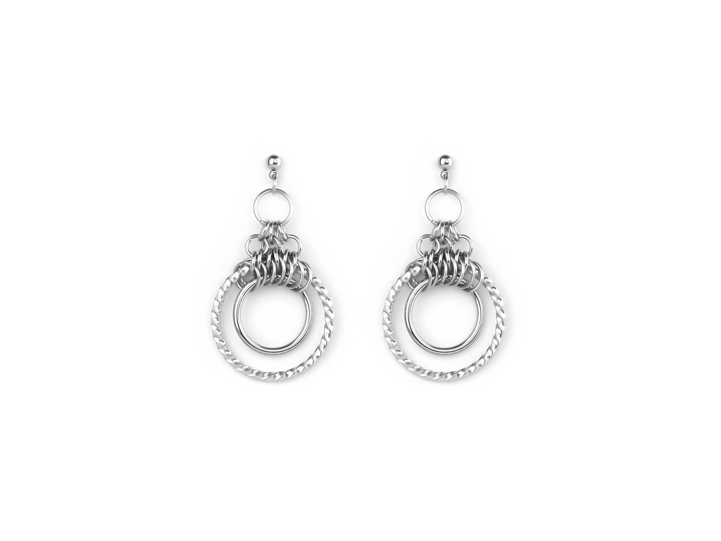 The image displays a pair of polished double hoop earrings with intricate detailing, likely from Myril Jewels. These earrings combine a classic hoop design with a smaller chained hoop, reflecting a modern twist on gothic-inspired jewelry. Ideal for adding an edgy yet sophisticated touch to any outfit, they could be a versatile accessory for Halloween, punk fashion enthusiasts, or anyone drawn to neo-gothic aesthetics. The simple elegance of these earrings makes them suitable for everyday wear