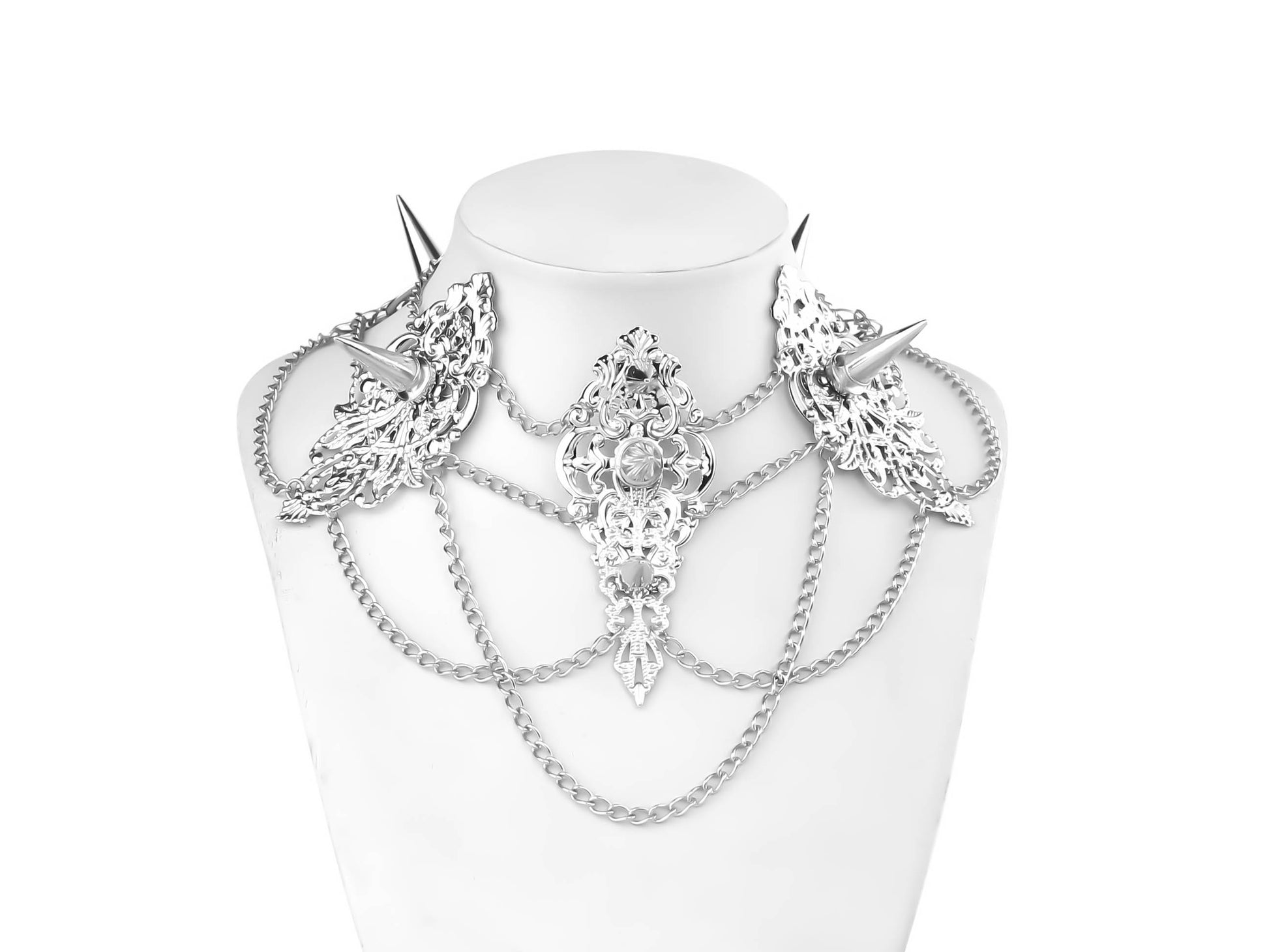 An intricately designed Myril Jewels studded choker featuring ornate filigree details and sharp, spiked elements. This bold, gothic-chic piece is interlaced with multiple chains, creating a captivating, layered look ideal for festival wear, drag queen ensembles, or as a standout gift for goth style lovers.