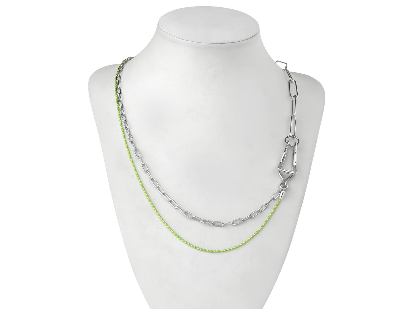 A Myril Jewels punk necklace features on a display, combining silver and vibrant green chains for a striking contrast. The design marries industrial and neo-gothic elements, creating an avant-garde accessory that's ideal for those with a love for gothic-chic and whimsigoth styles. This piece is versatile, suitable for everyday wear, yet bold enough for Halloween, and as a statement piece for rave parties or festivals