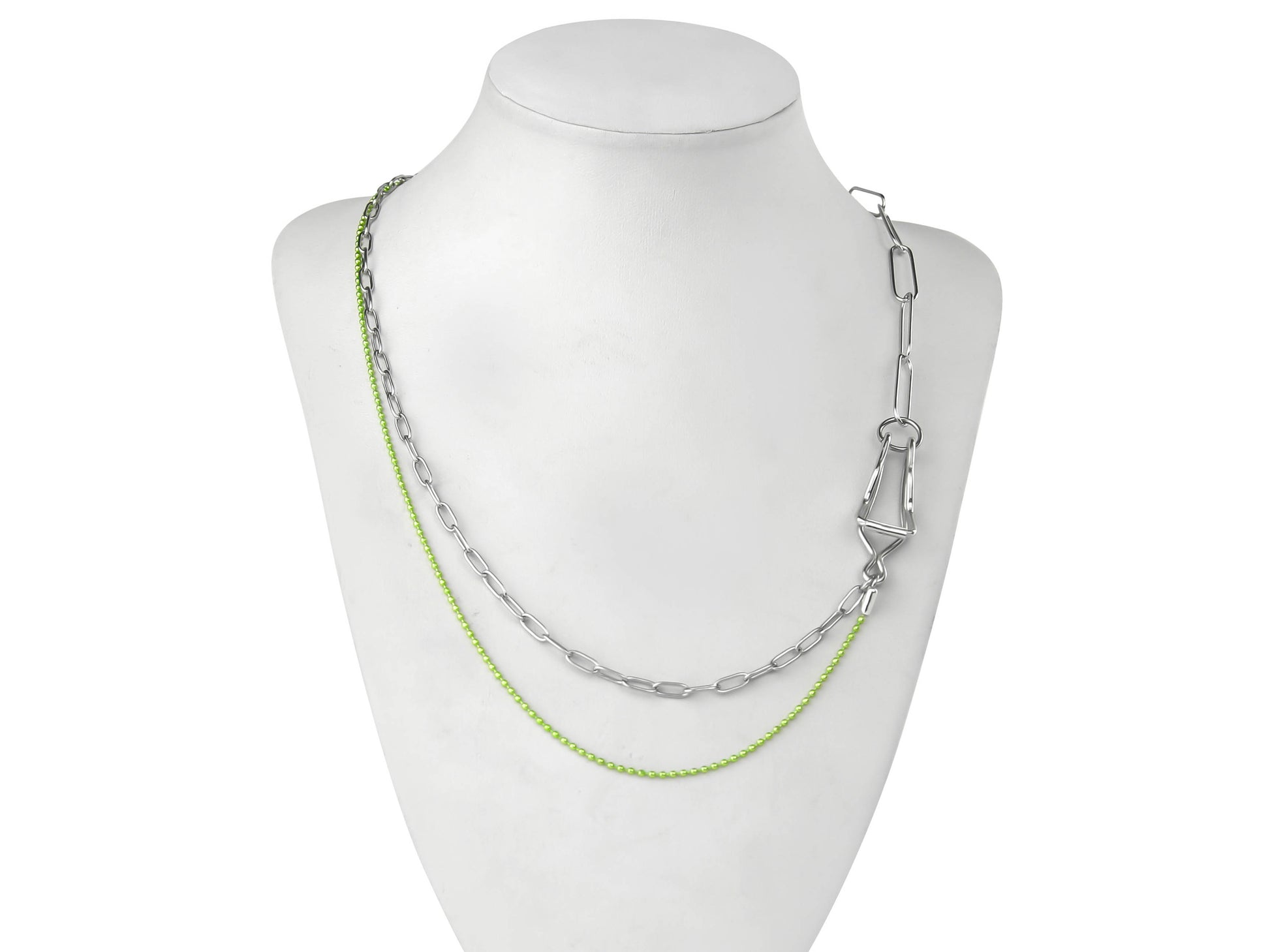 A Myril Jewels punk necklace features on a display, combining silver and vibrant green chains for a striking contrast. The design marries industrial and neo-gothic elements, creating an avant-garde accessory that's ideal for those with a love for gothic-chic and whimsigoth styles. This piece is versatile, suitable for everyday wear, yet bold enough for Halloween, and as a statement piece for rave parties or festivals