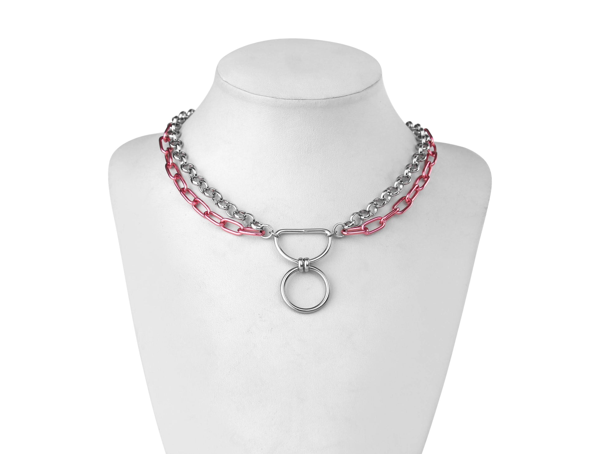 A Myril Jewels gothic punk necklace composed of alternating silver and vibrant pink chains features a prominent O-ring, exuding a mix of punk bravado and dark elegance. Ideal for Halloween adornment or daily wear, it's a statement piece for those with a taste for neo-gothic flair and avant-garde style.