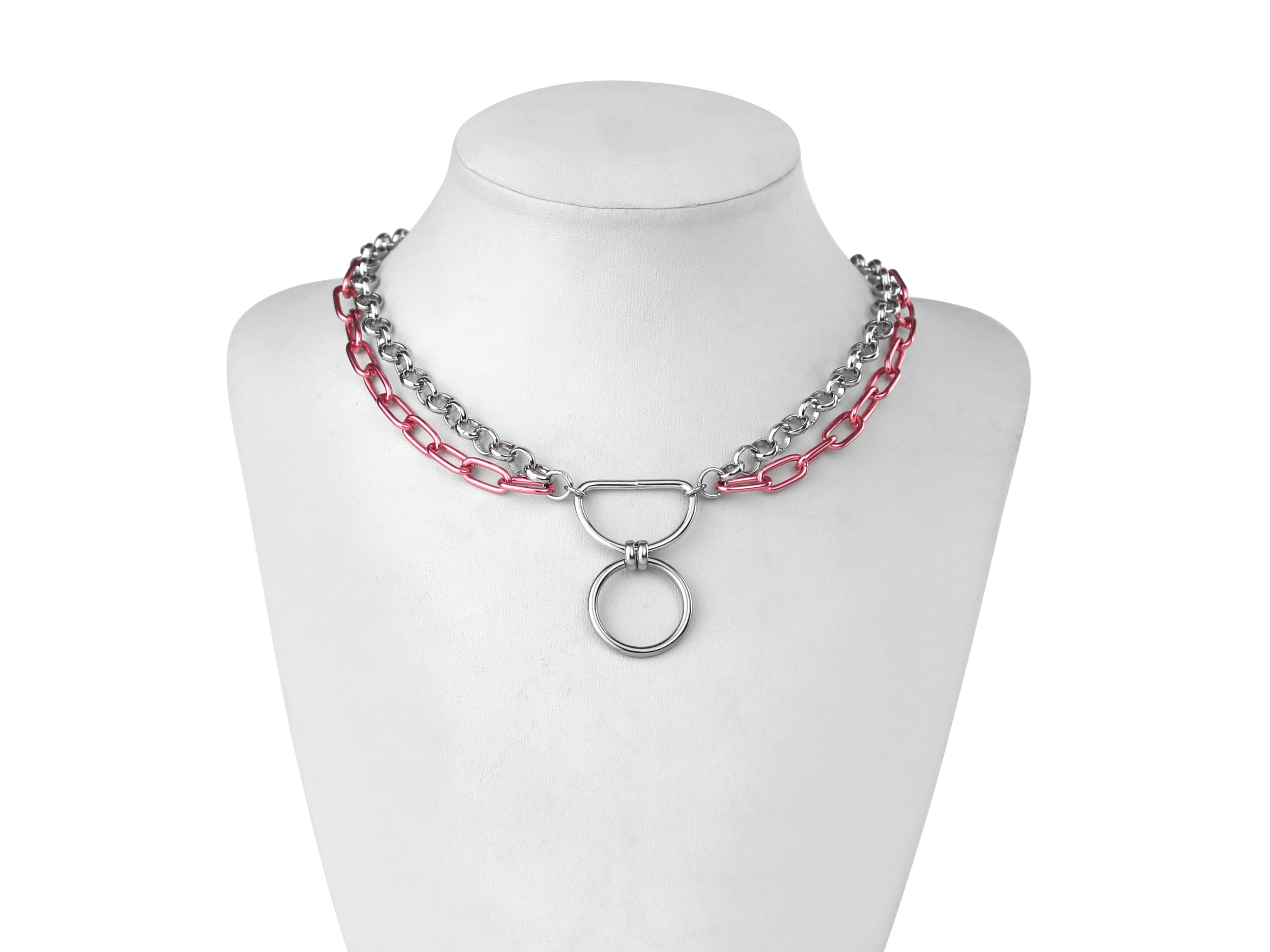 A Myril Jewels gothic punk necklace composed of alternating silver and vibrant pink chains features a prominent O-ring, exuding a mix of punk bravado and dark elegance. Ideal for Halloween adornment or daily wear, it's a statement piece for those with a taste for neo-gothic flair and avant-garde style.