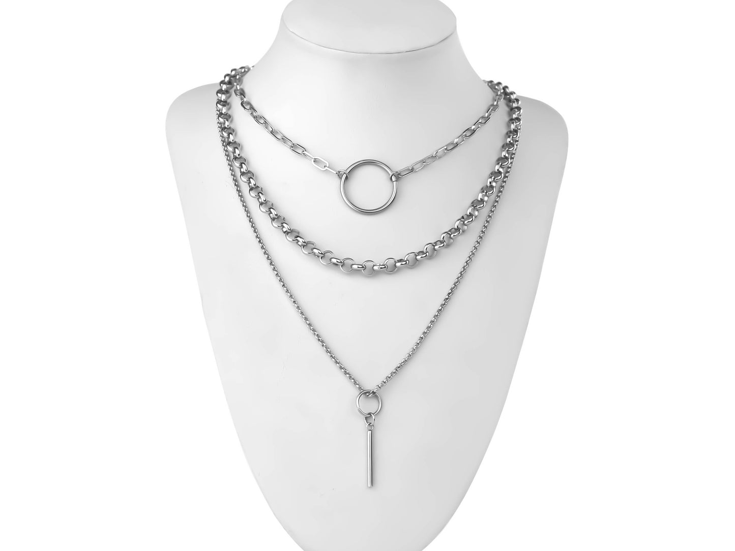 On a white display, a Myril Jewels punk multi-chain necklace cascades in layers, featuring an o-ring and a long pendant chain. This bold accessory is a statement in neo-gothic style, ideal for those embracing a gothic-chic or witchcore aesthetic in their everyday wear or as a standout piece for festivals.