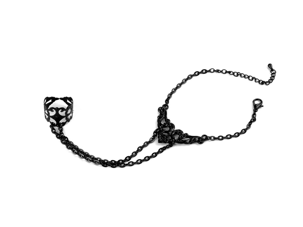 Indulge in the mysterious charm of Myril Jewels' hand chain bracelet ring, a darkly captivating piece for the avant-garde enthusiast. Intricate filigree forms the ring, connected to a chain of elegant black metal that drapes across the wrist, embodying the essence of Neo Gothic jewels. This handcrafted accessory is perfect for adding a touch of Gothic-chic to any ensemble, whether it's for Halloween, a rave party, or as an everyday statement piece for lovers of minimal goth
