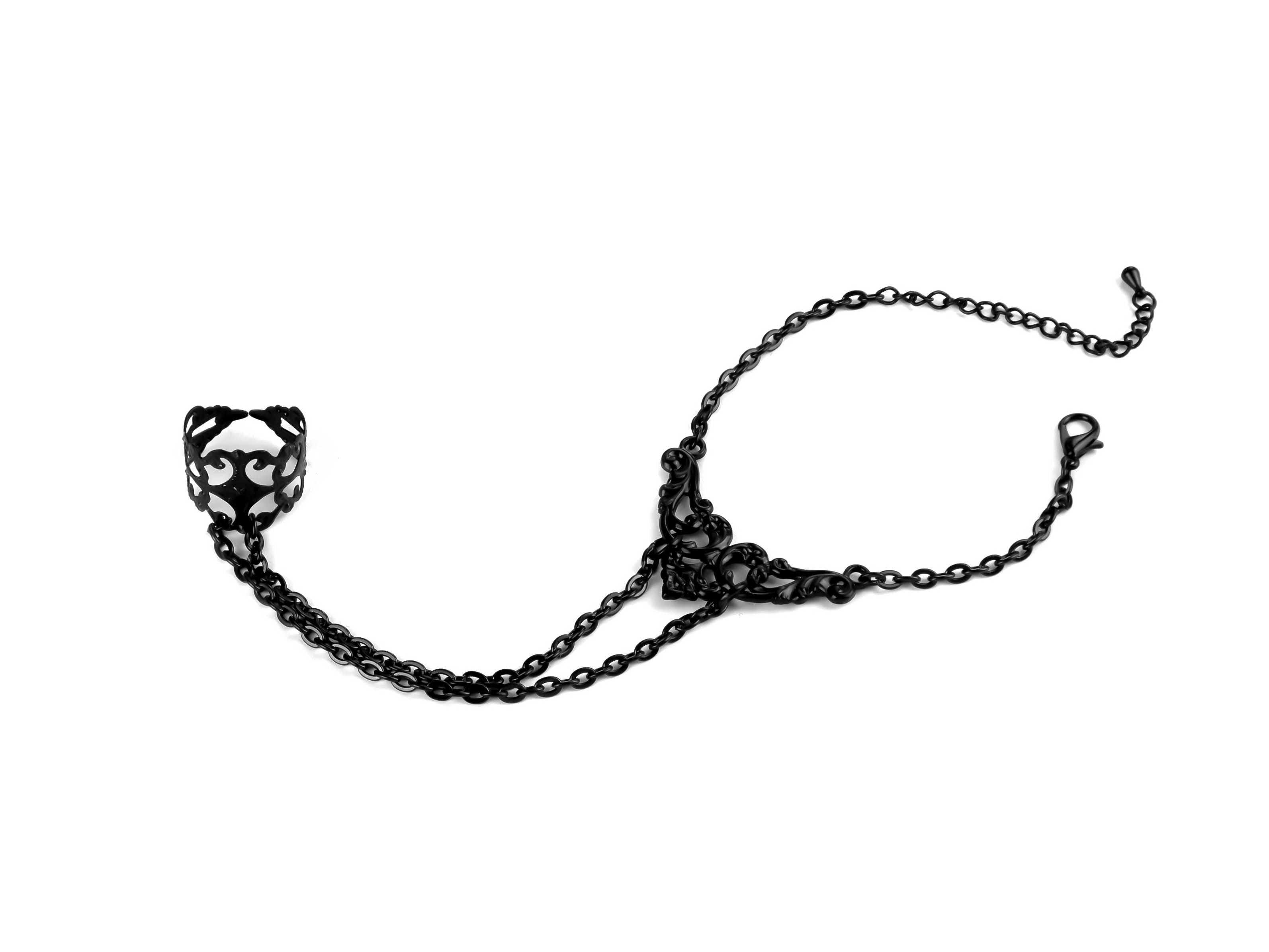 Indulge in the mysterious charm of Myril Jewels' hand chain bracelet ring, a darkly captivating piece for the avant-garde enthusiast. Intricate filigree forms the ring, connected to a chain of elegant black metal that drapes across the wrist, embodying the essence of Neo Gothic jewels. This handcrafted accessory is perfect for adding a touch of Gothic-chic to any ensemble, whether it's for Halloween, a rave party, or as an everyday statement piece for lovers of minimal goth