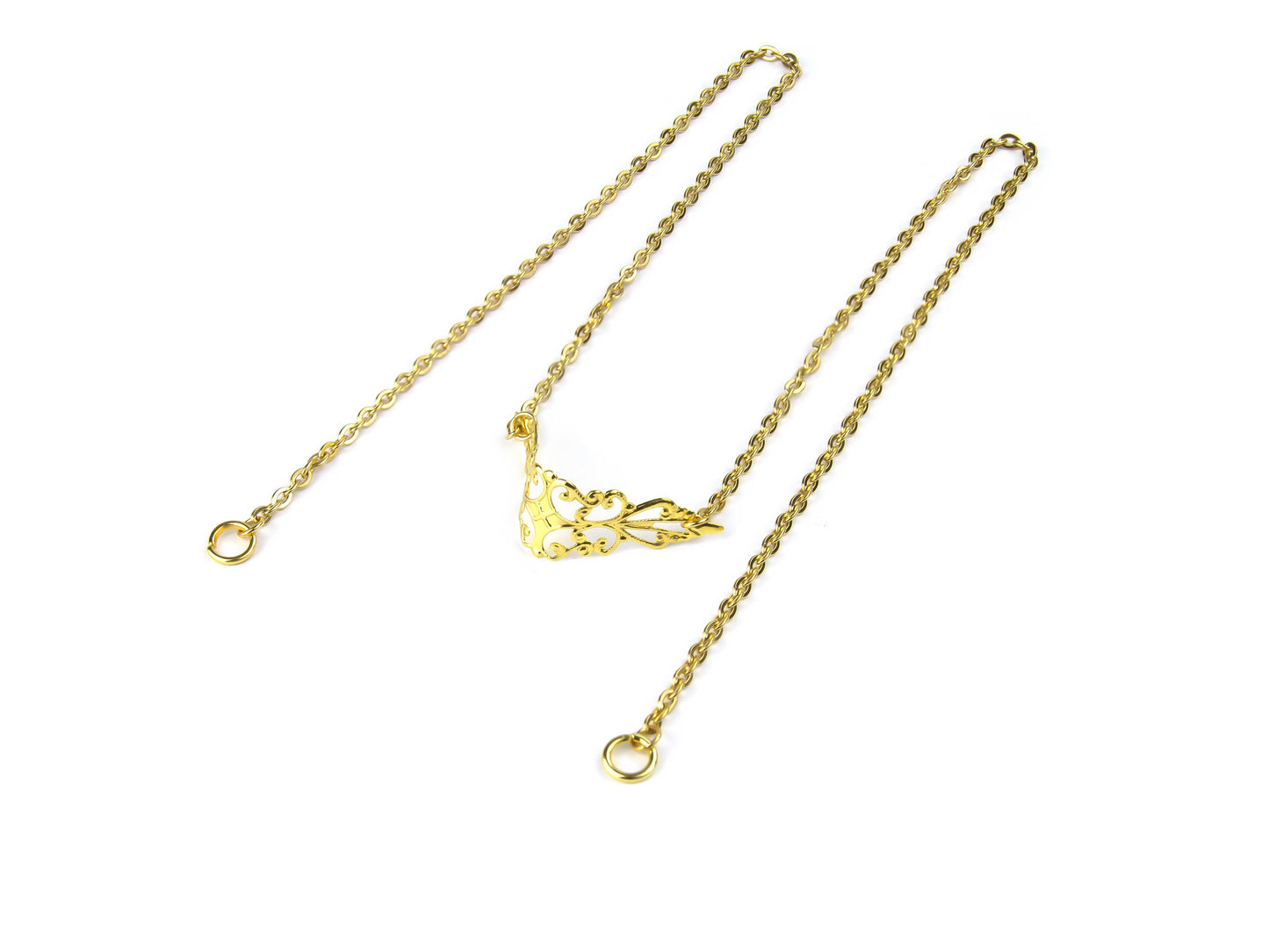 This image features a Myril Jewels gold nose chain with a delicate silver filigree design, laid out on a white background, capturing the essence of neo-gothic jewelry for a statement look