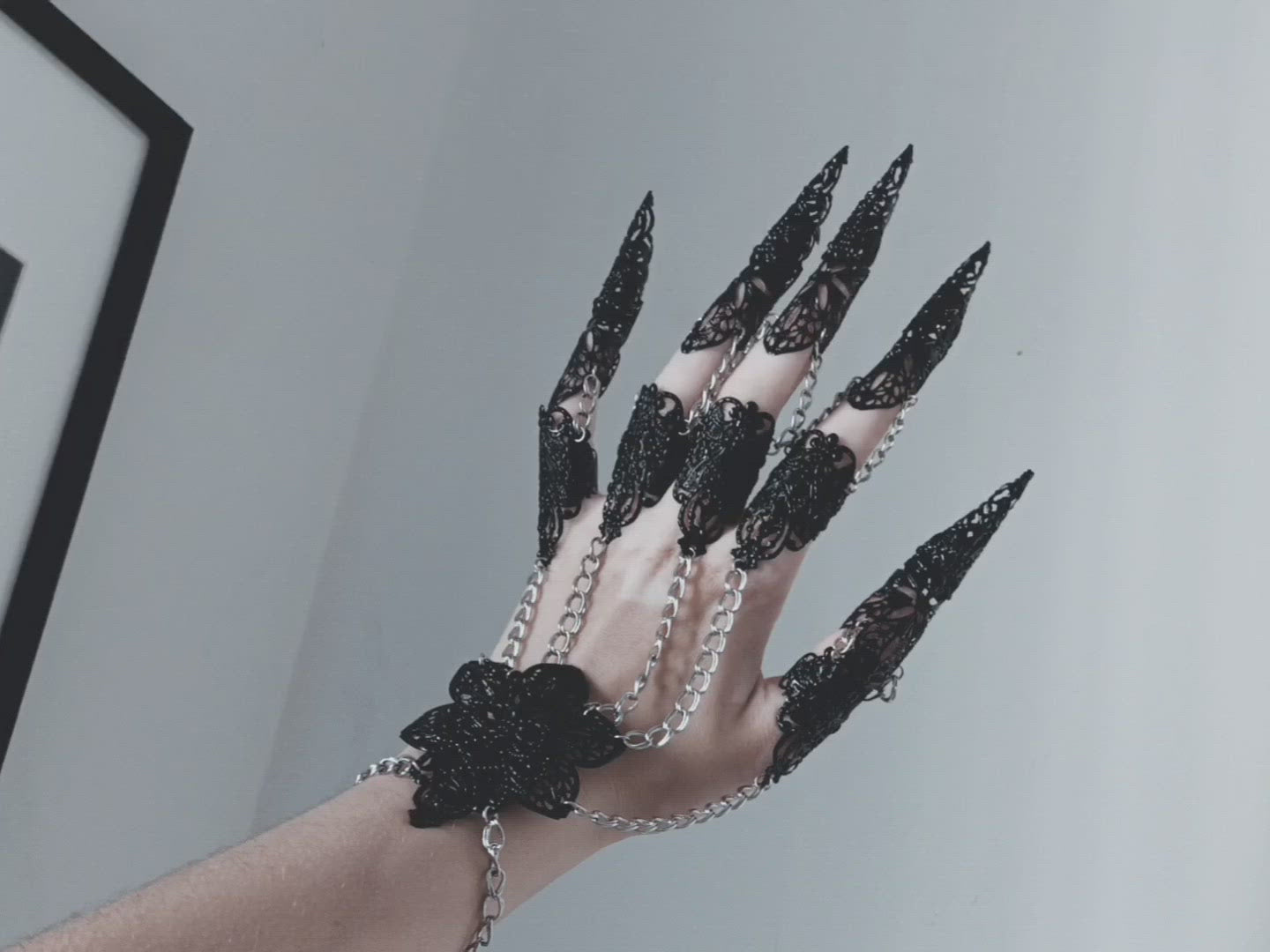 Immerse in the allure of Myril Jewels' black metal glove, a breathtaking embodiment of dark-avantgarde artistry. This hand-crafted masterpiece features elongated claw rings on each finger, creating an armor-like effect that captivates the essence of Neo Gothic style. Ideal for those drawn to the Gothic-chic and Witchcore aesthetics, this glove is a statement piece for Halloween, everyday minimal goth, and is bound to be the centerpiece in any Punk or Whimsigoth wardrobe. 