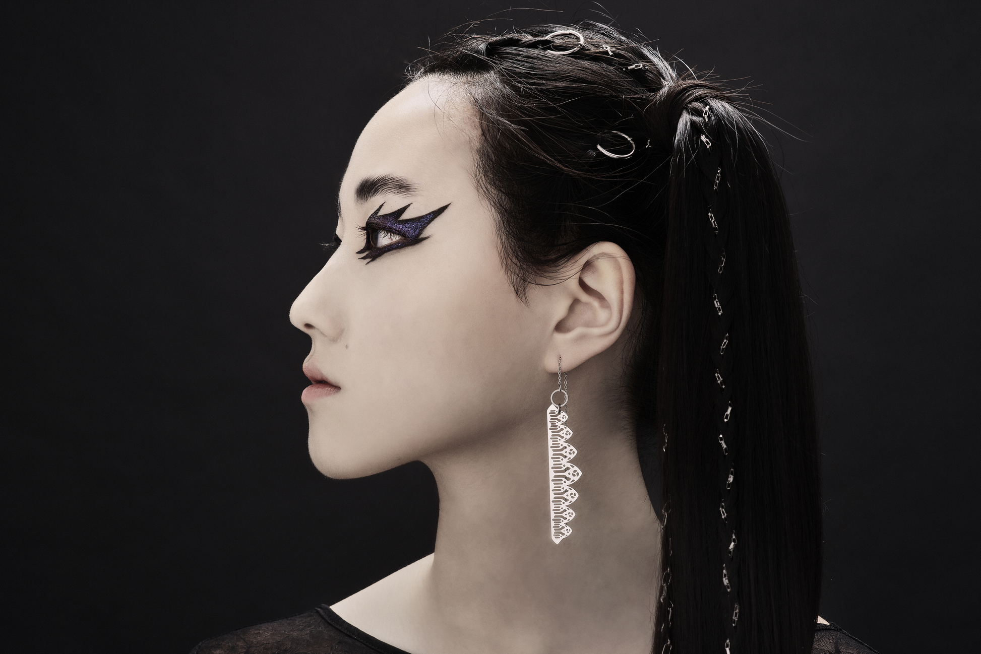 A profile view of a model showcases the intricate beauty of Myril Jewels' Goth Threader Earrings, designed with filigree inspired by gothic arches. These earrings are a testament to the Neo Gothic aesthetic, perfect for those who covet Halloween and everyday bold jewelry. Ideal for goth-chic enthusiasts, these earrings serve as a stunning statement piece or a thoughtful goth girlfriend gift