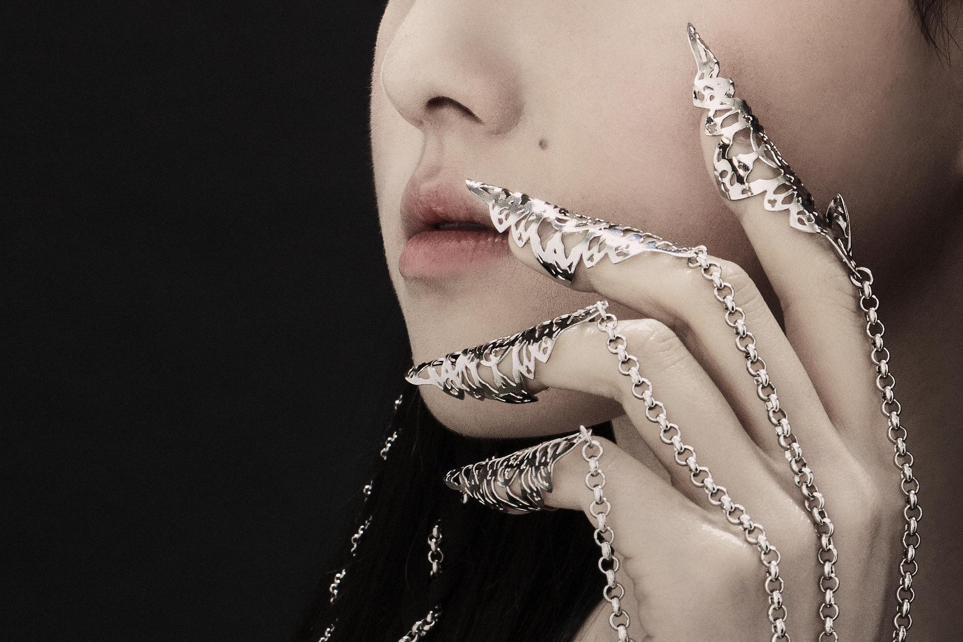 A captivating hand chain bracelet with nail claws from Myril Jewels, blending gothic allure and avant-garde design. This bold jewelry piece is perfect for those embracing a dark, whimsigoth aesthetic, ideal for adding a neo-gothic touch to any Halloween or festival outfit, or as a unique goth girlfriend gift