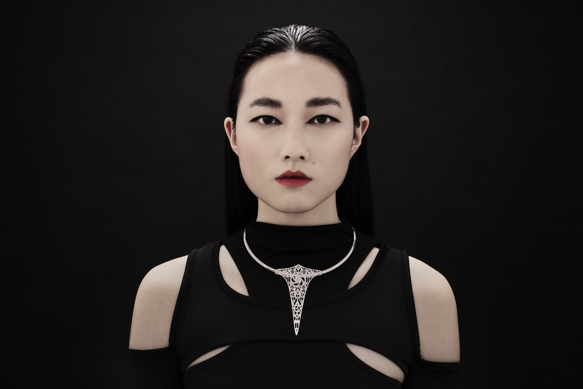 A model from Myril Jewels elegantly wears a rigid V-shaped necklace featuring a gothic churches motif. This piece is a testament to neo-gothic design, perfect for anyone who adores dark-avantgarde accessories, and is versatile enough for Halloween, everyday wear, or as a standout piece at a festival.