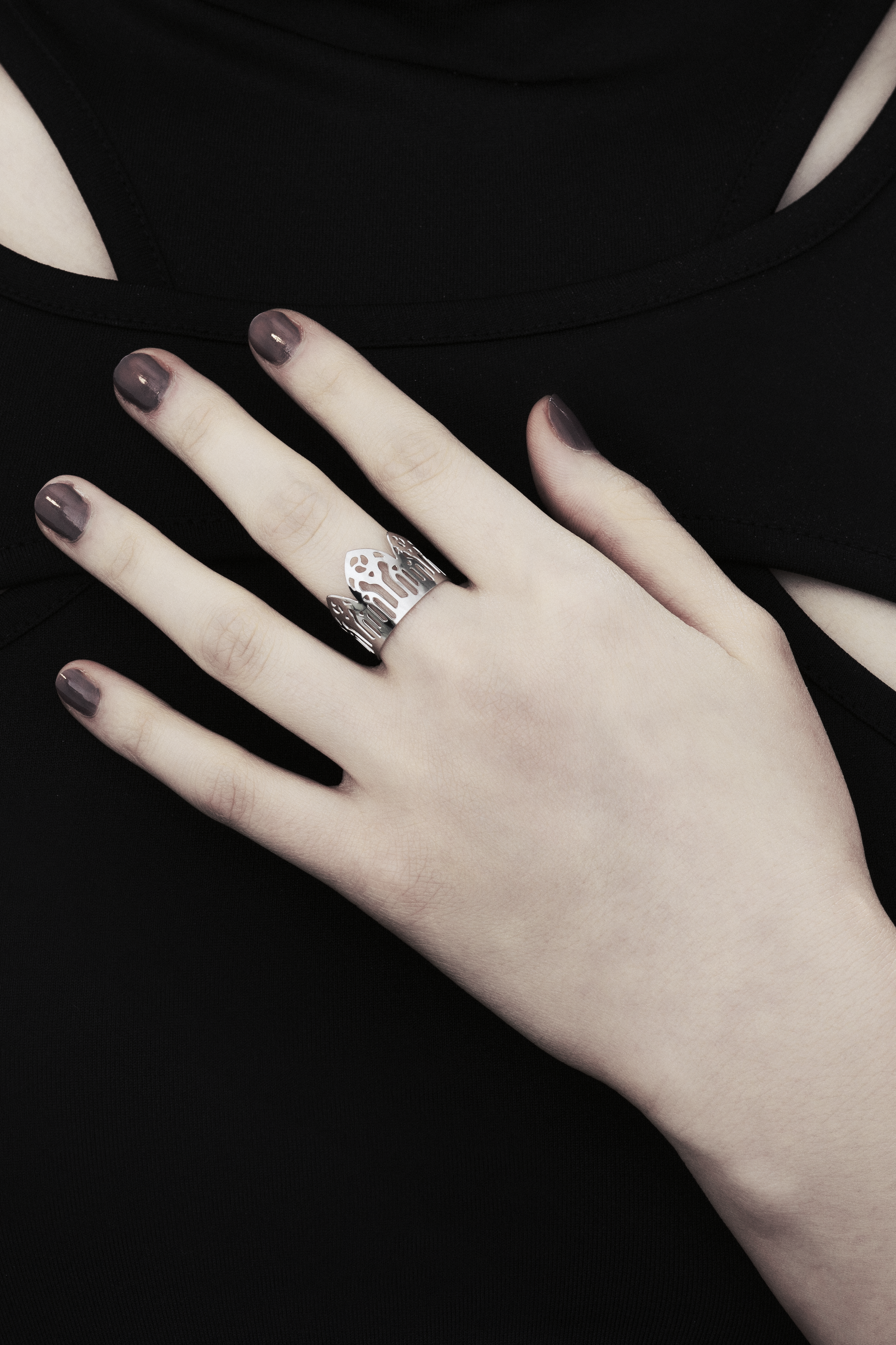 Showcased is a meticulously handcrafted Myril Jewels ring, adorned with detailed neo-gothic motifs. Perfect for aficionados of gothic and alternative fashions, this ring features a slim band echoing gothic arches, exuding a bold yet elegant vibe. Crafted in Italy, this piece captures the distinct, ever-evolving essence of Myril Jewels, crafted to appeal to the refined palate of gothic jewelry admirers.