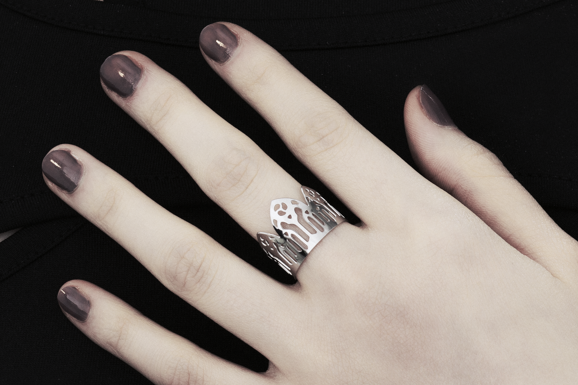 Showcased is a meticulously handcrafted Myril Jewels ring, adorned with detailed neo-gothic motifs. Perfect for aficionados of gothic and alternative fashions, this ring features a slim band echoing gothic arches, exuding a bold yet elegant vibe. Crafted in Italy, this piece captures the distinct, ever-evolving essence of Myril Jewels, crafted to appeal to the refined palate of gothic jewelry admirers.