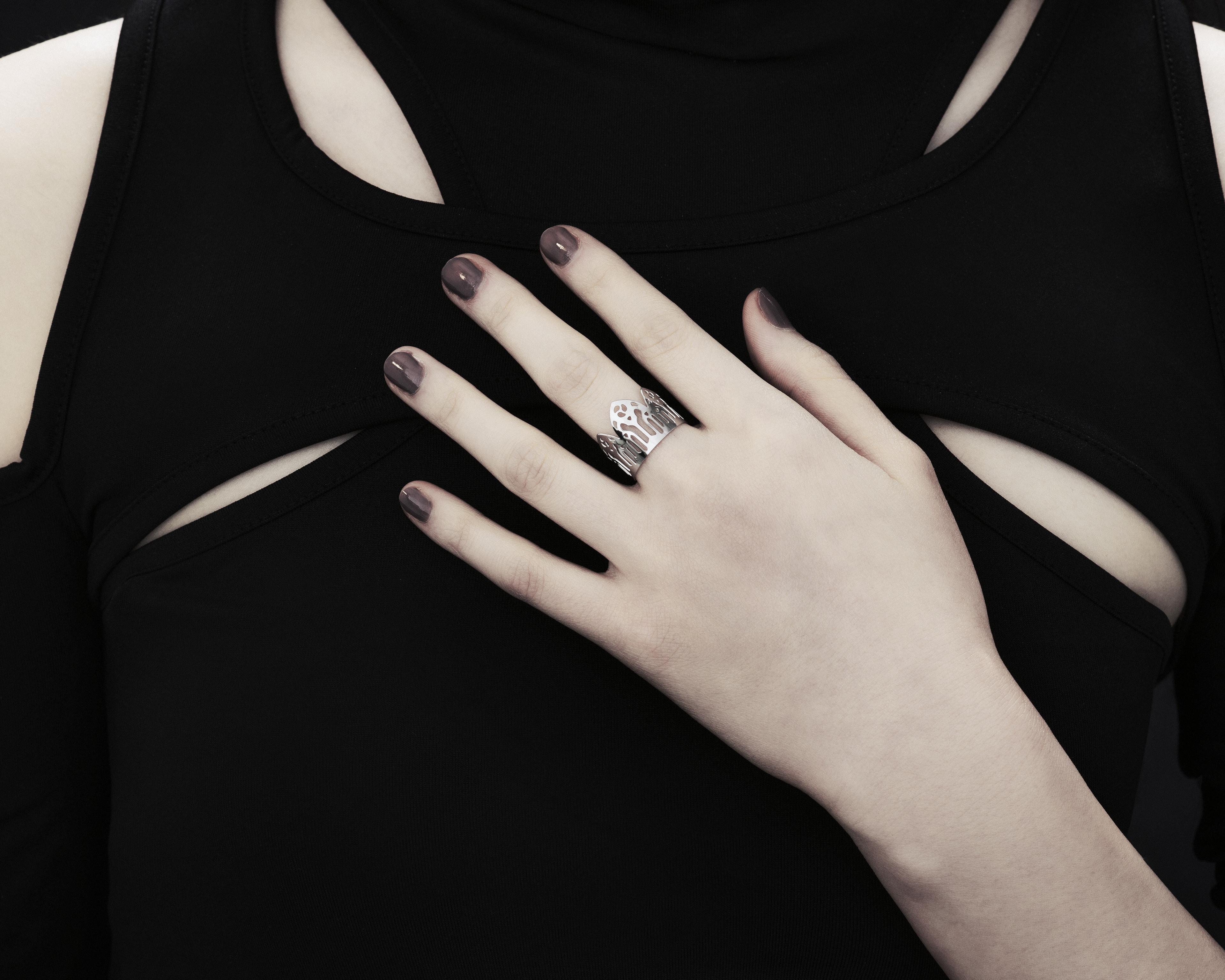 Showcased is a meticulously handcrafted Myril Jewels ring, adorned with detailed neo-gothic motifs. Perfect for aficionados of gothic and alternative fashions, this ring features a slim band echoing gothic arches, exuding a bold yet elegant vibe. Crafted in Italy, this piece captures the distinct, ever-evolving essence of Myril Jewels, crafted to appeal to the refined palate of gothic jewelry admirers.