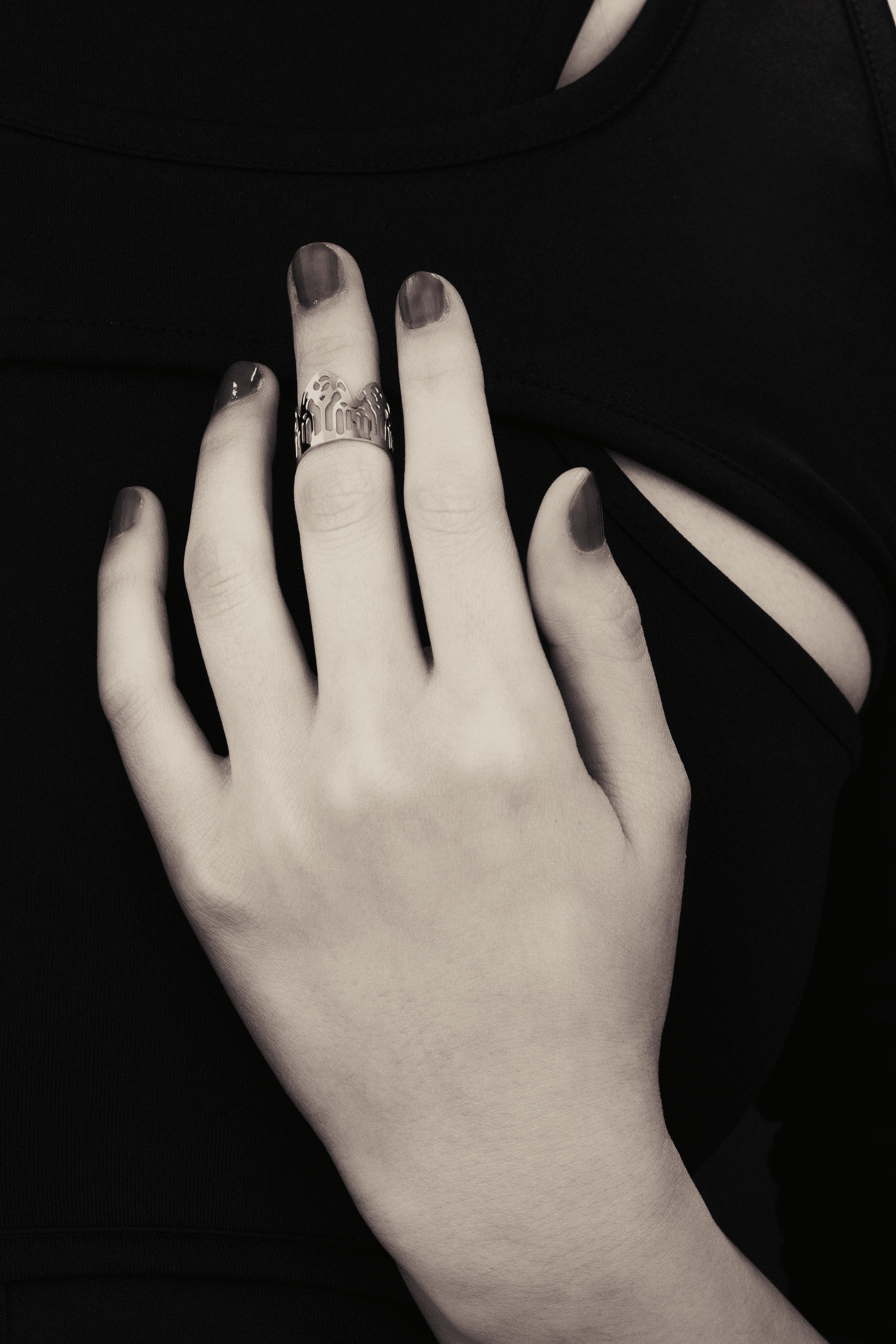 A showcase of Myril Jewels' artisanal, dark-avantgarde midi ring adorning a hand, detailed with complex gothic motifs, perfect for aficionados of gothic and alternative fashion. Crafted with slender bands that echo gothic arches, the ring offers a pronounced display of refined boldness. These pieces, forged in Italy, encapsulate the distinctive, progressive style of Myril Jewels, crafted for the sophisticated palate of the gothic jewelry admirer.