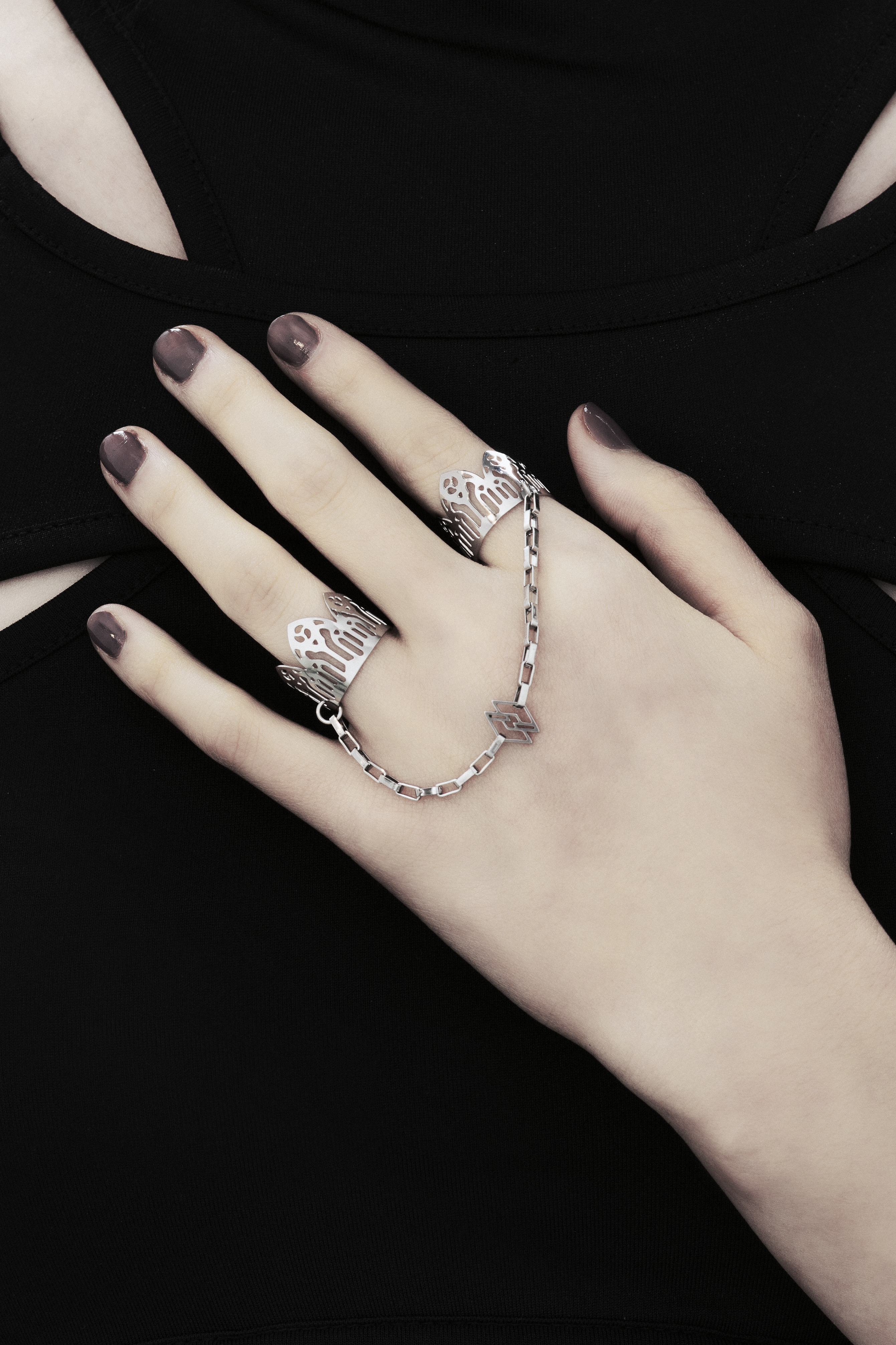 Featuring Myril Jewels' signature handcrafted flair, this double ring graces the hand with its gothic elegance, perfect for those with a penchant for alternative and gothic aesthetics. The slender band boasts gothic arch patterns, creating a distinctive statement of dark sophistication. Crafted in Italy, these rings capture the evolving sophistication of Myril Jewels, designed for the refined gothic jewelry aficionado.