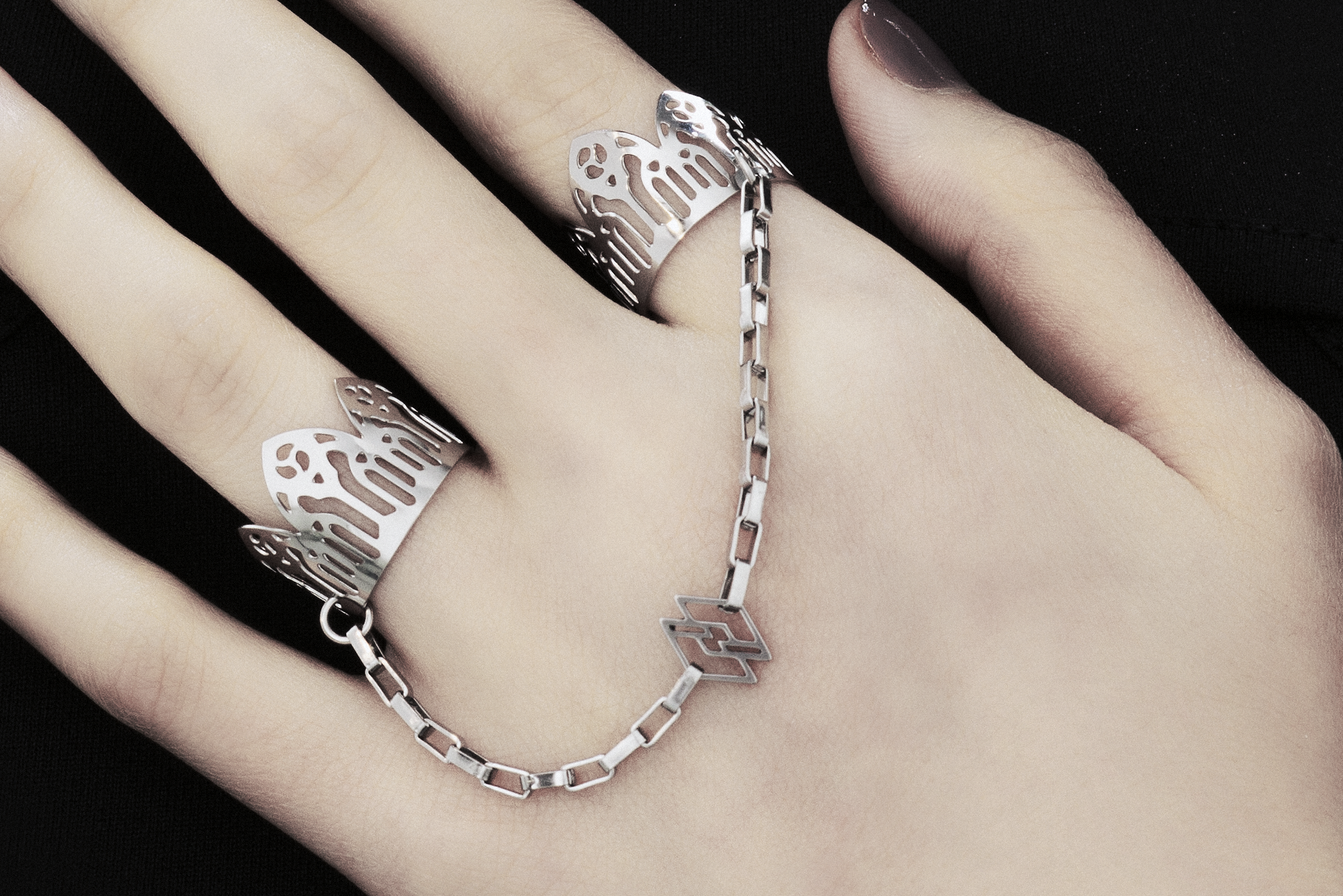 Featuring Myril Jewels' signature handcrafted flair, this double ring graces the hand with its gothic elegance, perfect for those with a penchant for alternative and gothic aesthetics. The slender band boasts gothic arch patterns, creating a distinctive statement of dark sophistication. Crafted in Italy, these rings capture the evolving sophistication of Myril Jewels, designed for the refined gothic jewelry aficionado.
