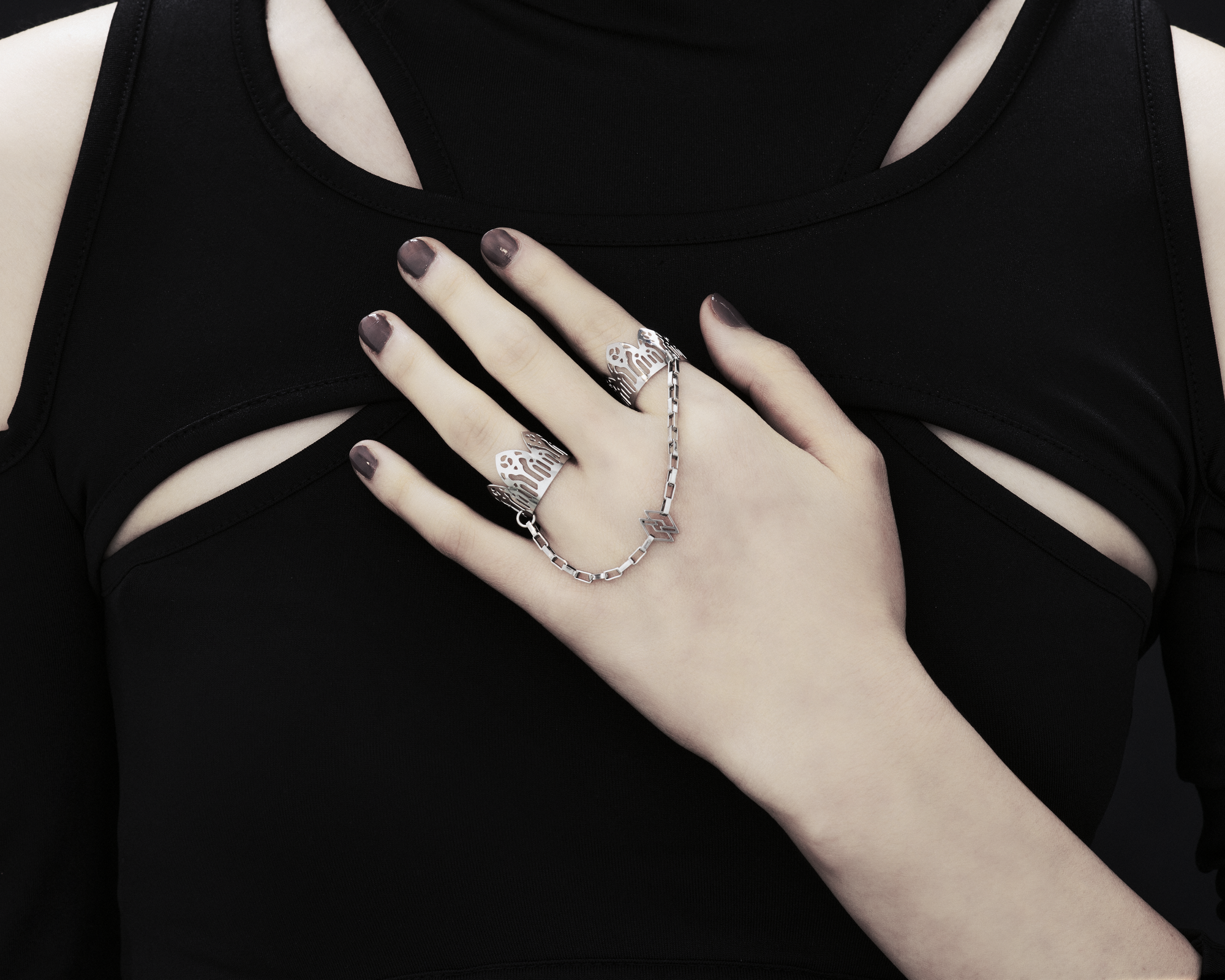 Behold a splendid exhibition of Myril Jewels' hand-wrought, avant-garde double rings, adorned upon a hand. Each ring flaunts elaborate designs inspired by Gothic artistry, catering to aficionados of the gothic and alternative fashion spheres. Crafted with a delicate band that echoes the majestic forms of gothic cathedrals, the rings make a sophisticated statement. These creations, forged in Italy, capture the distinct and dynamic essence of Myril Jewels