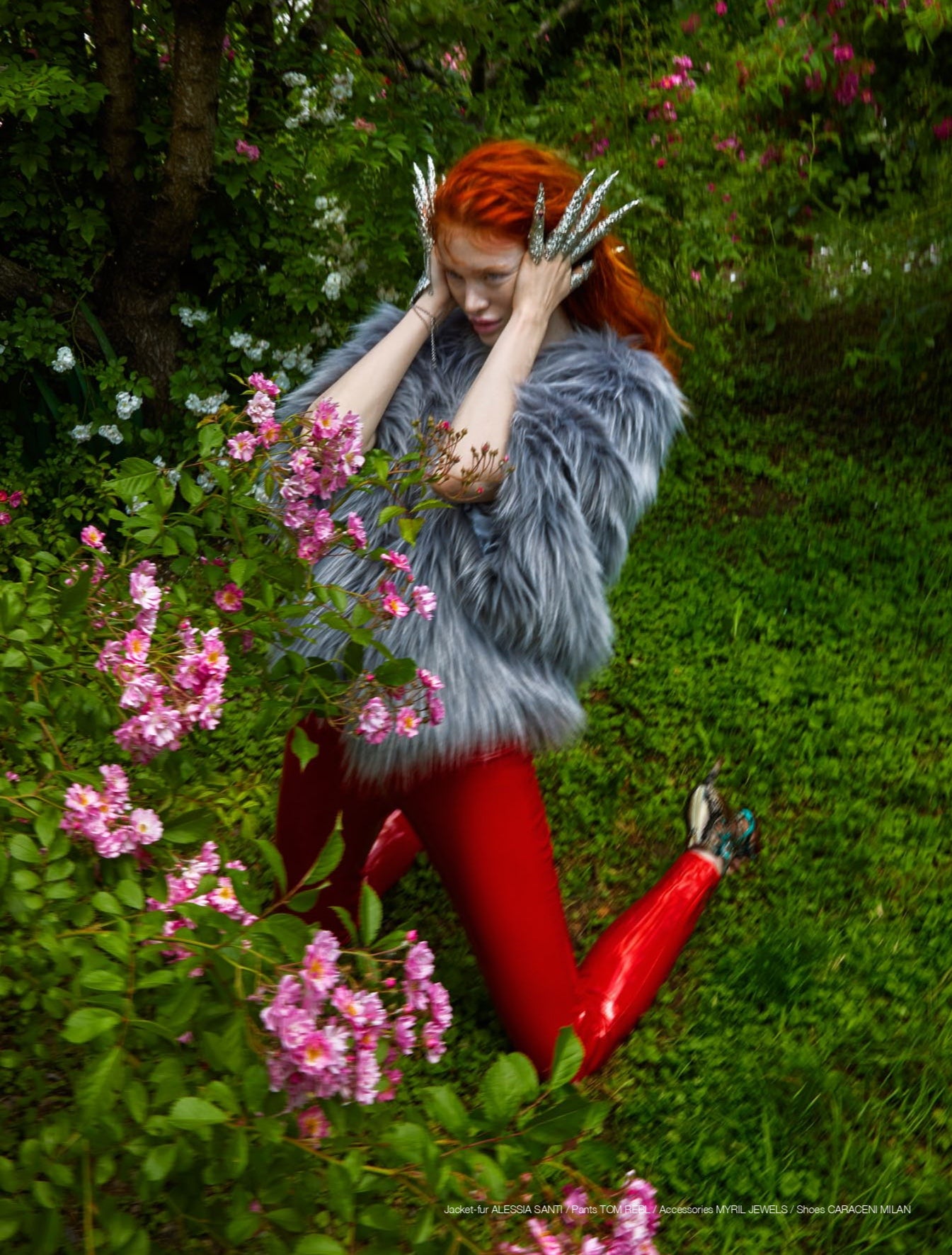In a vibrant garden, a model with fiery red hair poses in a whirl of motion, her Myril Jewels full finger claw rings catching the light. The rings' edgy design adds a neo-gothic touch to her eclectic look, perfect for those seeking bold, Witchcore-inspired jewelry.