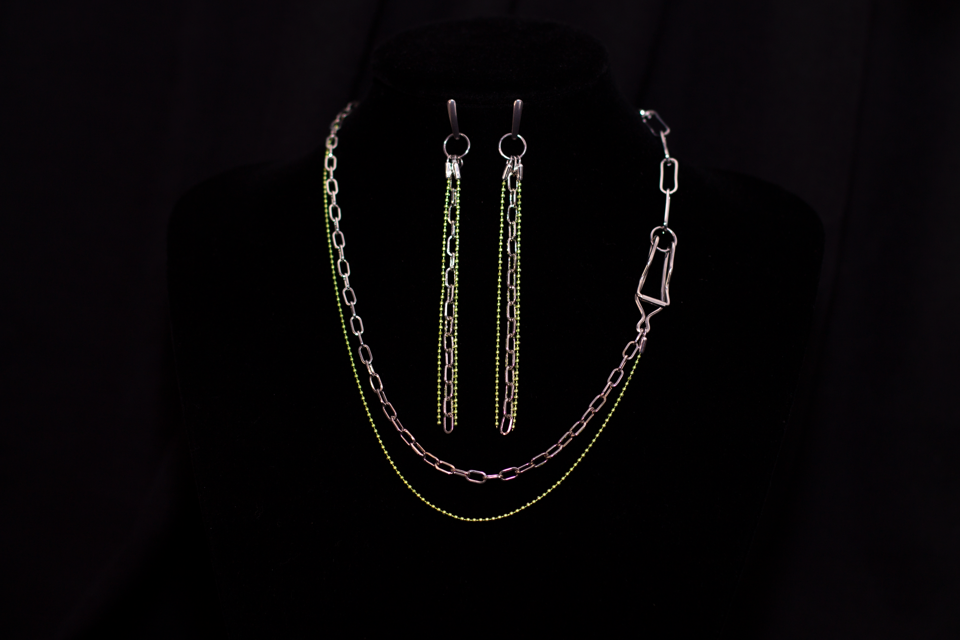 An exquisite Myril Jewels set, featuring neo-gothic long-chain earrings and a matching necklace, perfect for goth and alternative fashion enthusiasts. The silver links are accented with vibrant green beads, encapsulating a gothic-chic vibe. This bold jewelry set serves as a statement piece for rave parties or as a distinct goth girlfriend gift, embodying the whimsigoth and witchcore essence in every detail.