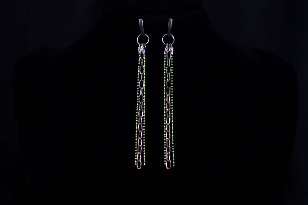 These Myril Jewels earrings showcase a neo-gothic allure, perfect for those embracing a dark-avantgarde style. The design features elongated chains adorned with shimmering green beads, reflecting an edgy yet chic aesthetic. Ideal for goth girlfriend gifts or as bold, festival-ready accessories, these earrings exude a minimalist goth vibe that complements both everyday wear and Halloween festivities.