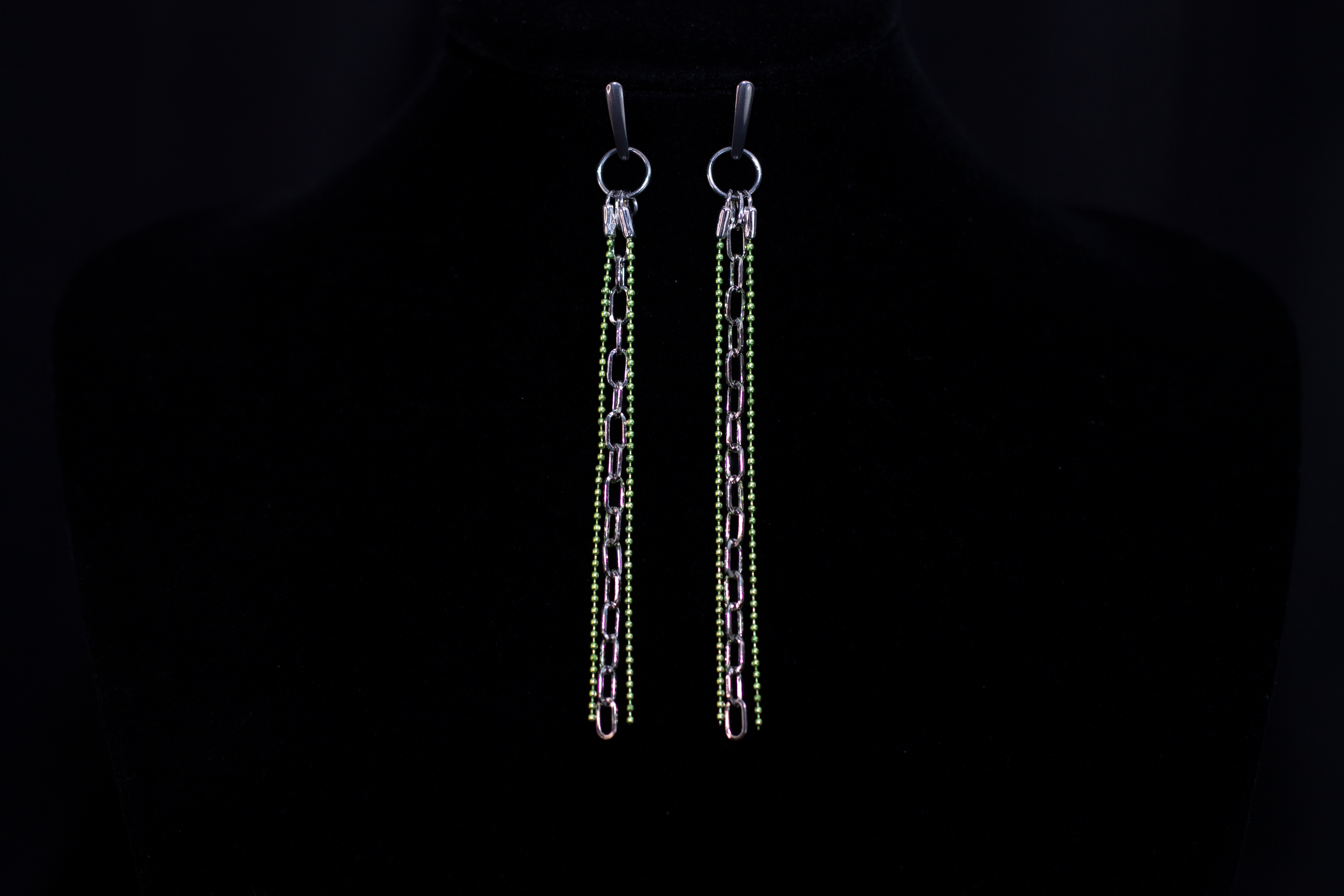 These Myril Jewels earrings showcase a neo-gothic allure, perfect for those embracing a dark-avantgarde style. The design features elongated chains adorned with shimmering green beads, reflecting an edgy yet chic aesthetic. Ideal for goth girlfriend gifts or as bold, festival-ready accessories, these earrings exude a minimalist goth vibe that complements both everyday wear and Halloween festivities.