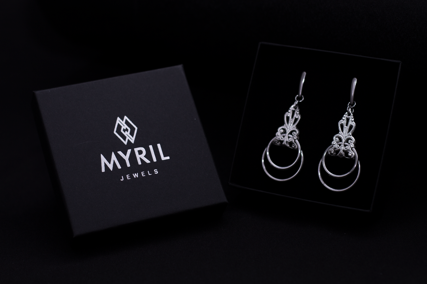 Alt text: "Exclusive Myril Jewels presentation with a pair of Neo Gothic silver earrings elegantly displayed against a black background, highlighting the brand's dark-avantgarde aesthetic. These earrings are perfect for Gothic-chic, Whimsigoth, and everyday wear, making them a versatile addition to any Witchcore or alternative style collection. Ideal for those who appreciate a touch of edgy sophistication in their jewelry, Myril Jewels offers the quintessence of handcrafted Italian craftsmanship