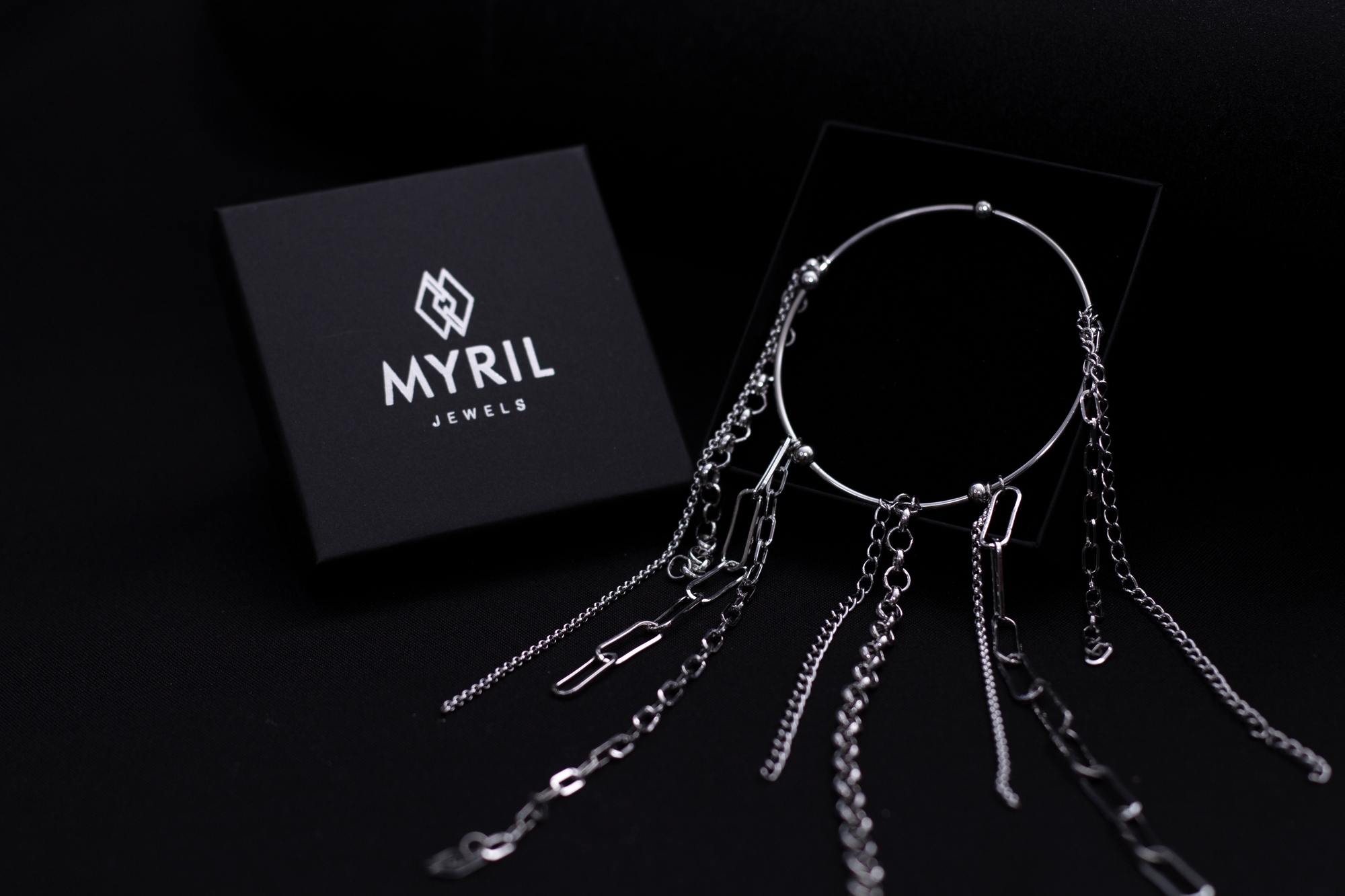 levate your gothic wardrobe with Myril Jewels' rigid bracelet adorned with delicate chains, embodying a darkly elegant neo-goth aesthetic, perfect for everyday wear or as a striking statement piece.