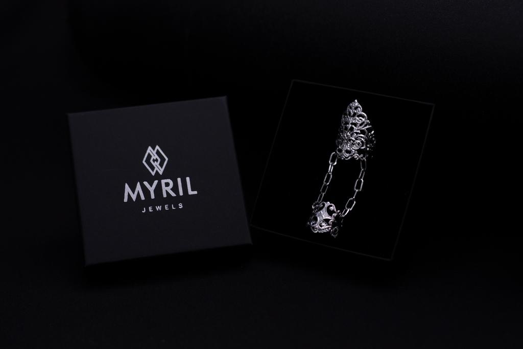 Discover the allure of Myril Jewels with this exquisite gothic double ring, displayed against a sleek, branded black box. This signature piece embodies the essence of neo-gothic jewelry, perfect for goth enthusiasts seeking a bold, witchcore-inspired statement. Ideal for Halloween, rave parties, or as a cherished gift for someone special.