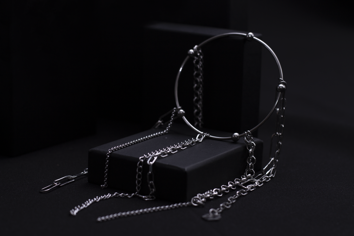 levate your gothic wardrobe with Myril Jewels' rigid bracelet adorned with delicate chains, embodying a darkly elegant neo-goth aesthetic, perfect for everyday wear or as a striking statement piece.
