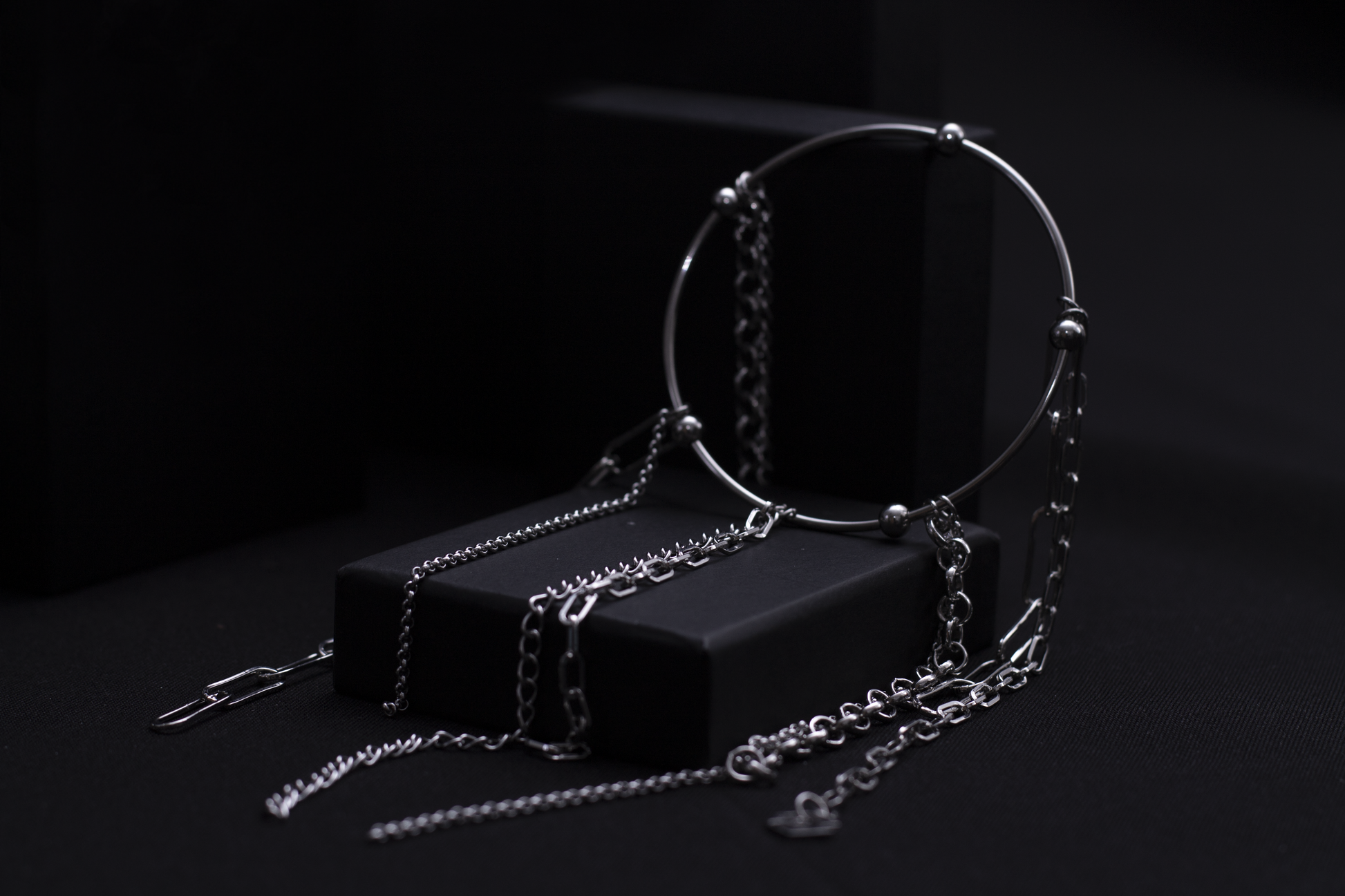 levate your gothic wardrobe with Myril Jewels' rigid bracelet adorned with delicate chains, embodying a darkly elegant neo-goth aesthetic, perfect for everyday wear or as a striking statement piece.