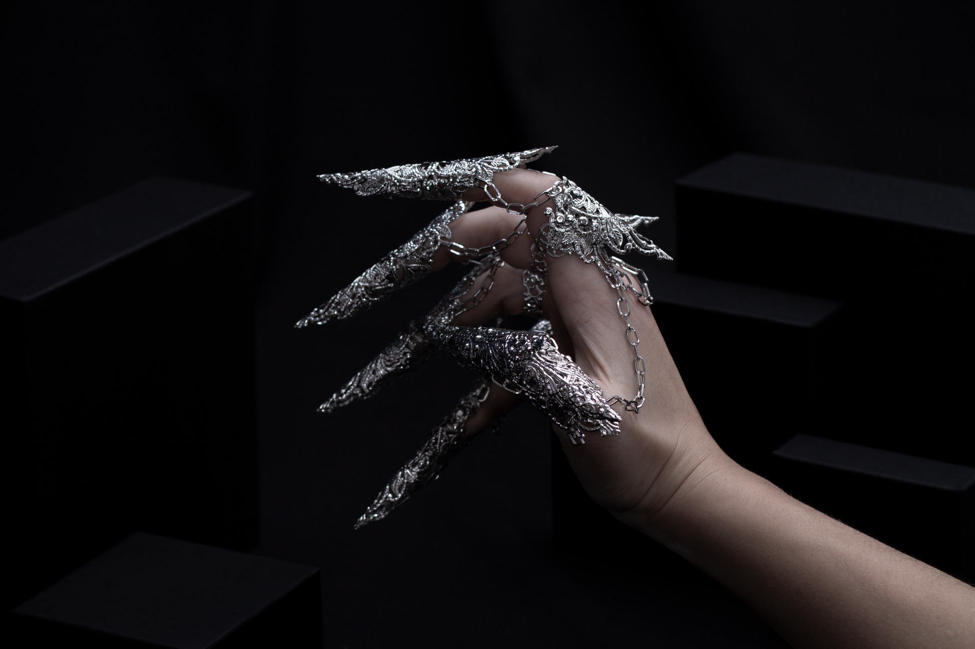 A hand is dramatically transformed with Myril Jewels' full set of dragon-like long claw rings, crafted with an intricate silver design. These neo-goth masterpieces are a perfect match for anyone passionate about bold, dark, avant-garde fashion, and make a statement at any gothic, festival, or Halloween event.