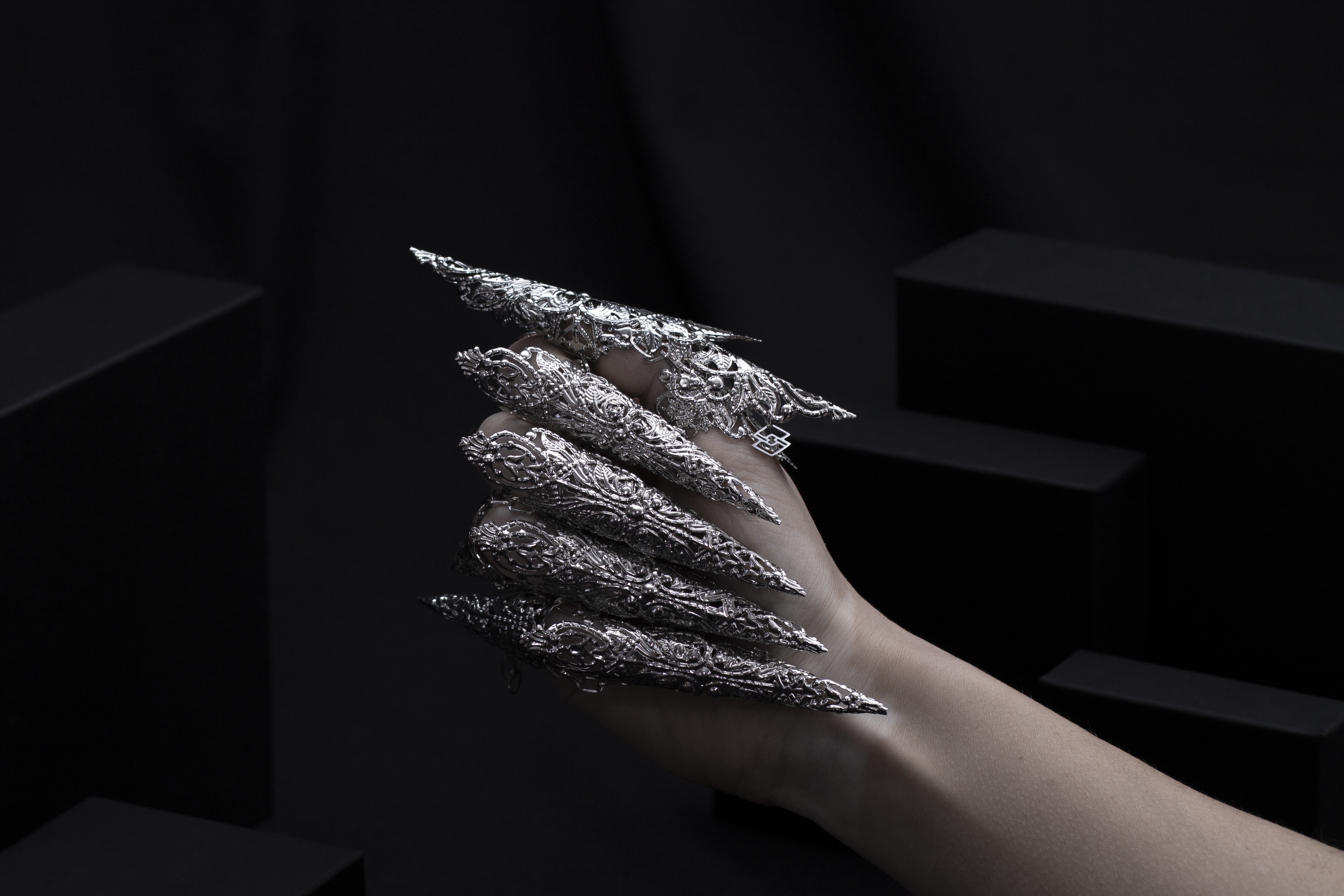 A hand is dramatically transformed with Myril Jewels' full set of dragon-like long claw rings, crafted with an intricate silver design. These neo-goth masterpieces are a perfect match for anyone passionate about bold, dark, avant-garde fashion, and make a statement at any gothic, festival, or Halloween event.