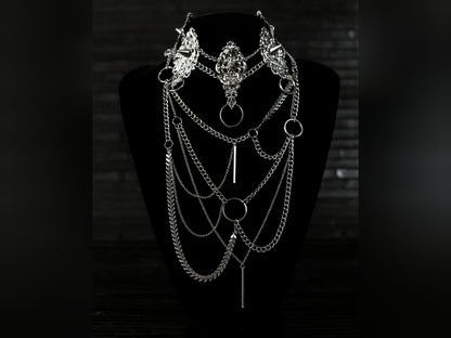 Myril Jewels presents an exquisite punk studded metal choker paired with a multi-layer long chain necklace, embodying the dark avant-garde spirit. This Italian handcrafted ensemble is a testament to the fusion of Neo Gothic flair and Gothic-chic, perfect for Halloween, everyday wear, or any whimsigoth and witchcore inspired look. The layered chains add depth to the minimal goth aesthetic, making it a versatile statement piece for alternative style connoisseurs