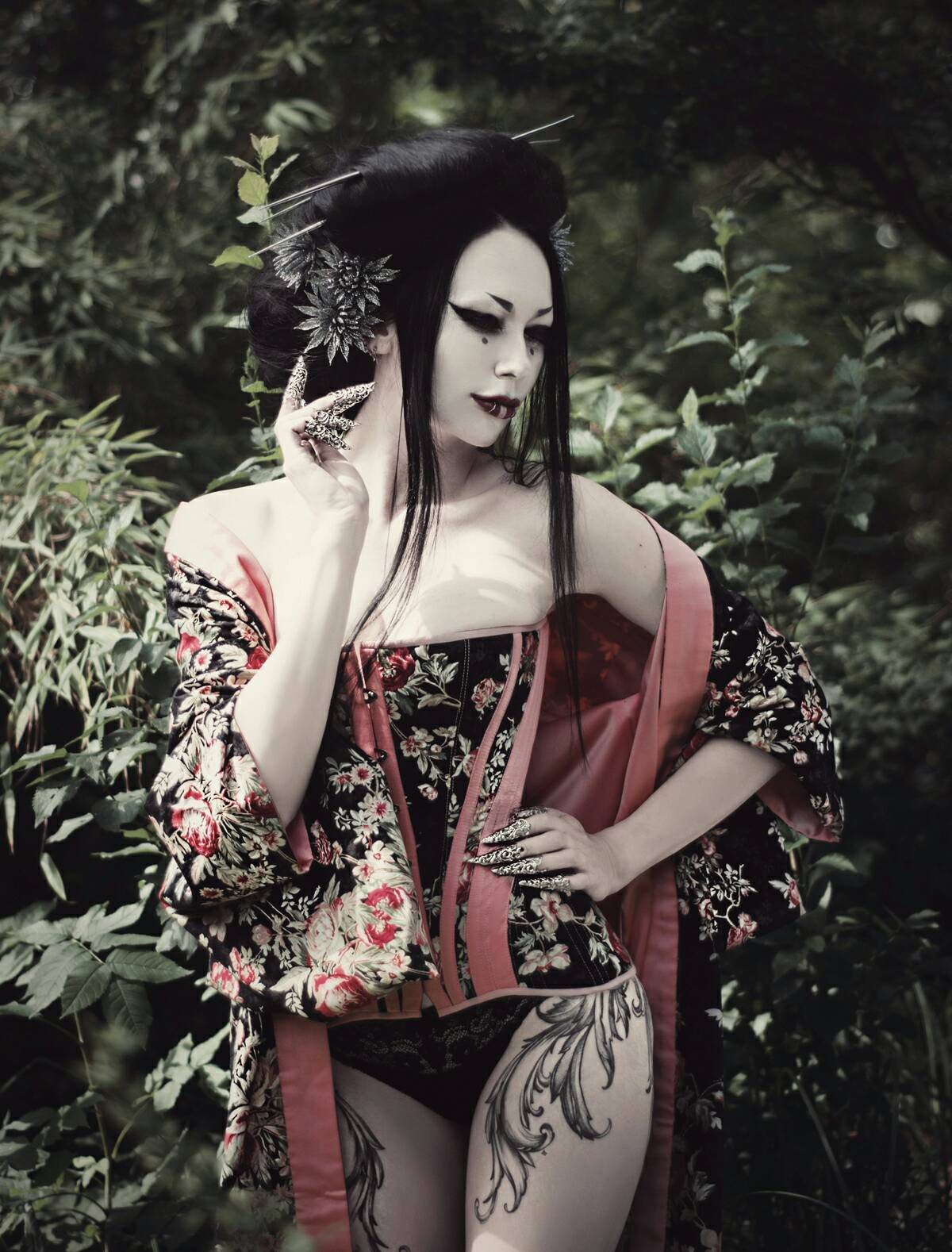 Mysterious goth geisha adorned with Myril Jewels' long finger claws, evoking neo-gothic elegance. The claws complement her dramatic attire, perfect for goth enthusiasts or as an audacious statement at a festival, adding a whimsigoth touch to a Halloween or rave party ensemble.