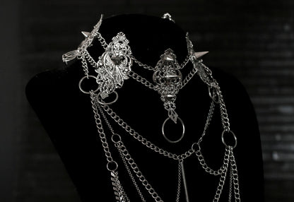 Myril Jewels presents an exquisite punk studded metal choker paired with a multi-layer long chain necklace, embodying the dark avant-garde spirit. This Italian handcrafted ensemble is a testament to the fusion of Neo Gothic flair and Gothic-chic, perfect for Halloween, everyday wear, or any whimsigoth and witchcore inspired look. The layered chains add depth to the minimal goth aesthetic, making it a versatile statement piece for alternative style connoisseurs