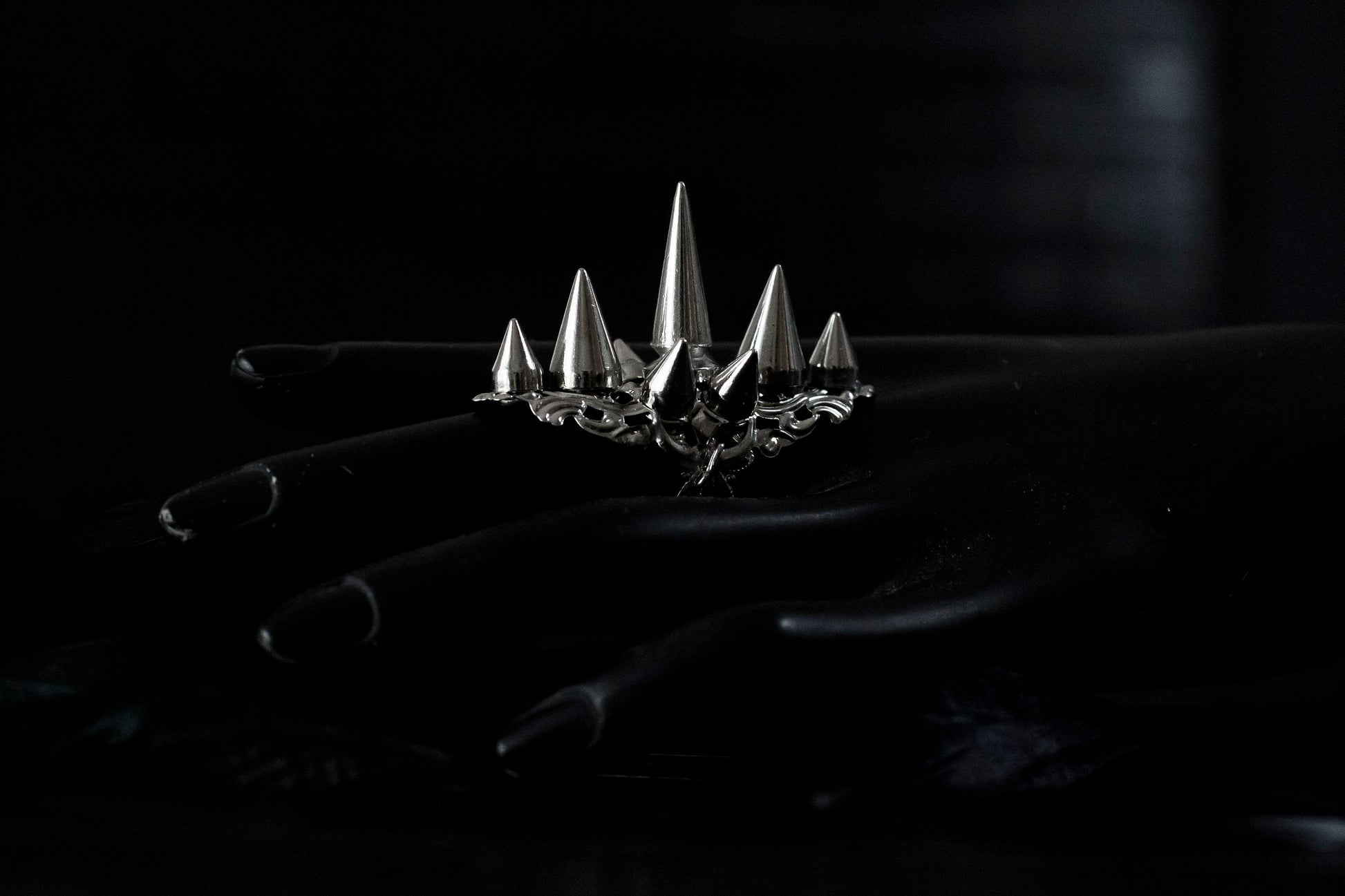 this Myril Jewels silver punk studded ring makes a bold statement with its sharp, gleaming spikes and intricate filigree detailing. Crafted for the dark avant-garde jewelry aficionado, it's a piece that commands attention, perfect for Halloween, embracing the Neo Gothic vibe, or elevating everyday wear with a touch of gothic-chic. Ideal for those who identify with the Whimsigoth or Witchcore aesthetic, or for anyone looking to add an edge to their minimal goth style.