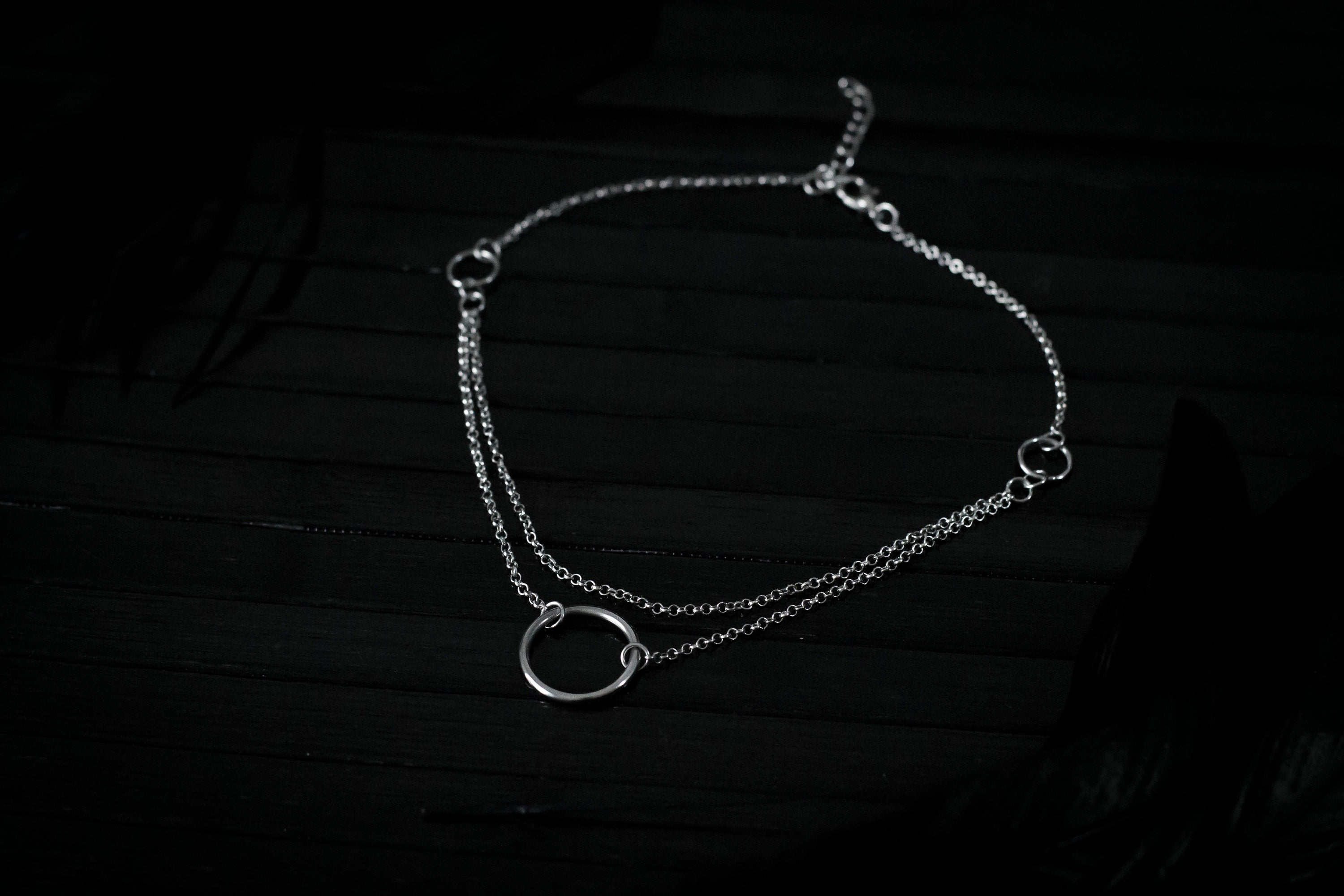 Elegant Myril Jewels chain necklace, featuring a prominent central o-ring, embodies the essence of neo-gothic charm. Designed for goth and alternative style connoisseurs, this piece serves as a versatile accessory for everyday wear or as a bold statement for festival and rave attire. Perfect for those seeking a touch of Halloween or Punk Jewelry, it's an ideal goth girlfriend gift or a distinctive friend gift idea.