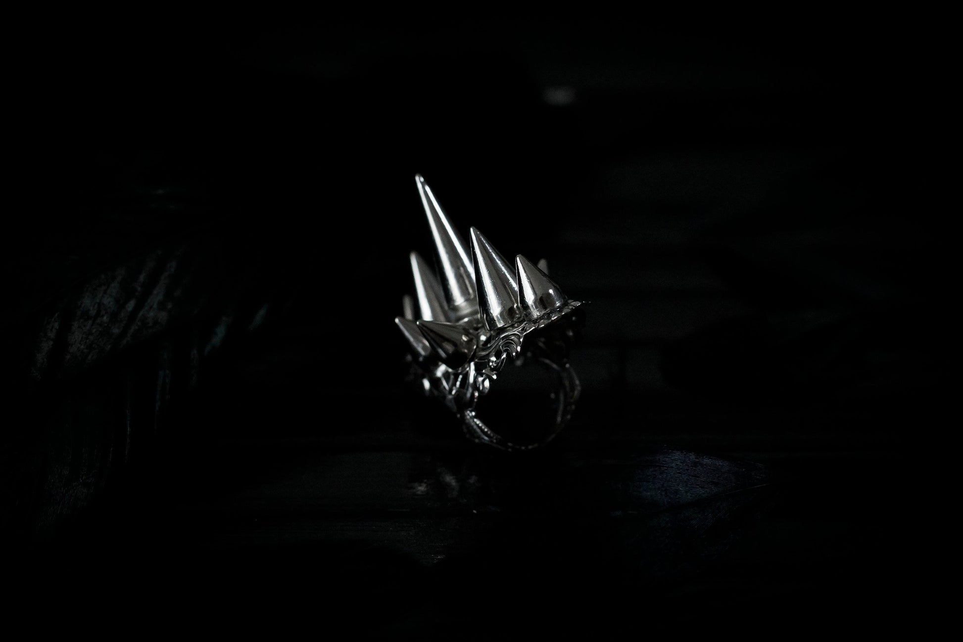 This bold Myril Jewels punk studded ring stands out with its gleaming silver spikes and intricate filigree detailing that pays homage to Neo Gothic craftsmanship. Perfect for anyone seeking a statement piece that channels Gothic-chic or Witchcore vibes, the ring is a quintessential accessory for Halloween, dramatic everyday wear, and a striking complement to any minimal goth or Whimsigoth inspired outfit.