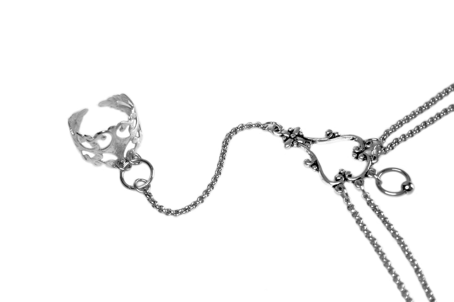 Elegant Myril Jewels slave bracelet ring with filigree detailing and connecting chains, showcasing the artistry of neo-goth design for a sophisticated, dark-avantgarde accessory.